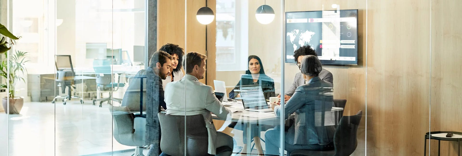 Team discussion in a modern glass-walled office