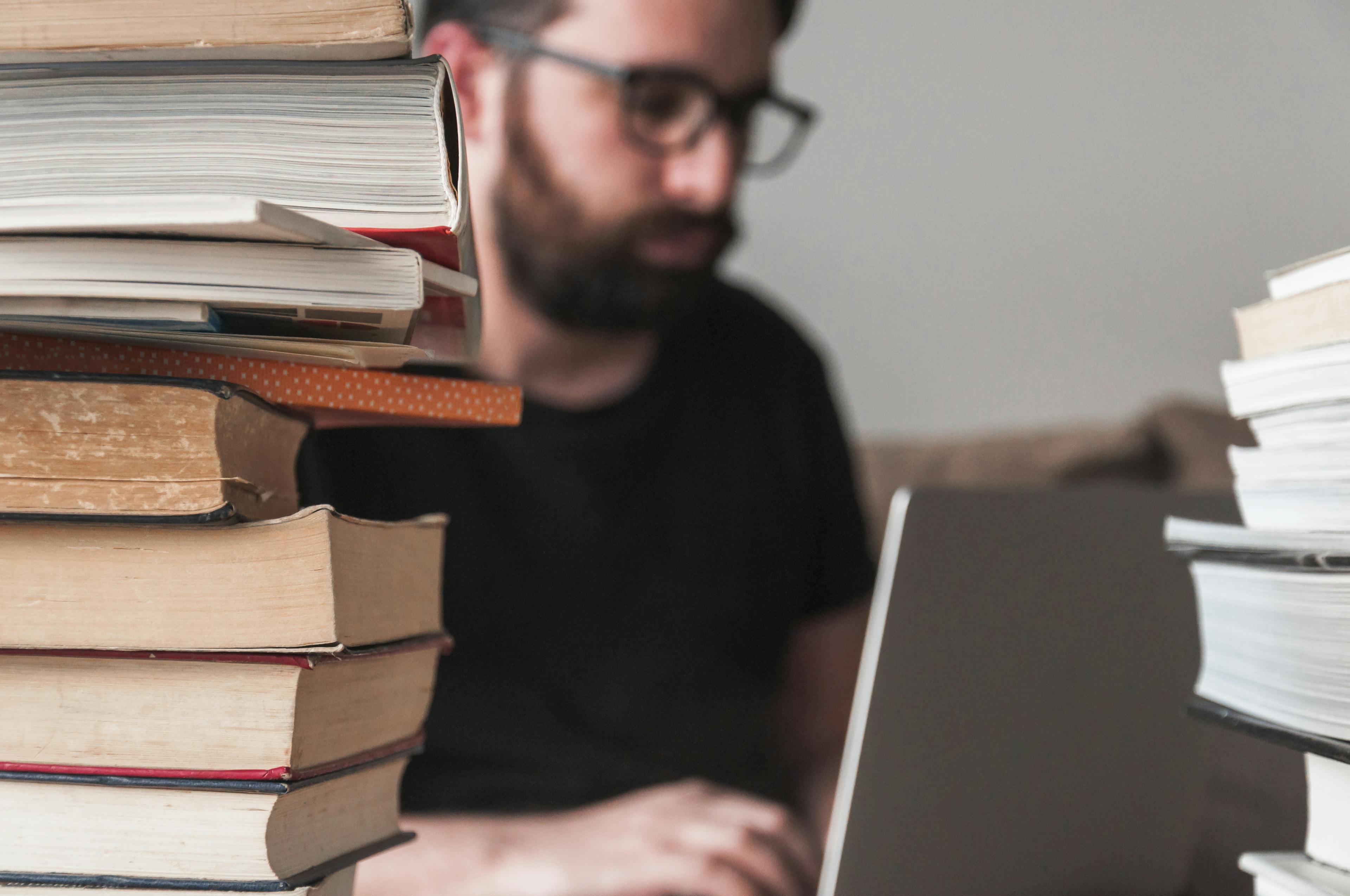 books besides a man with a laptop