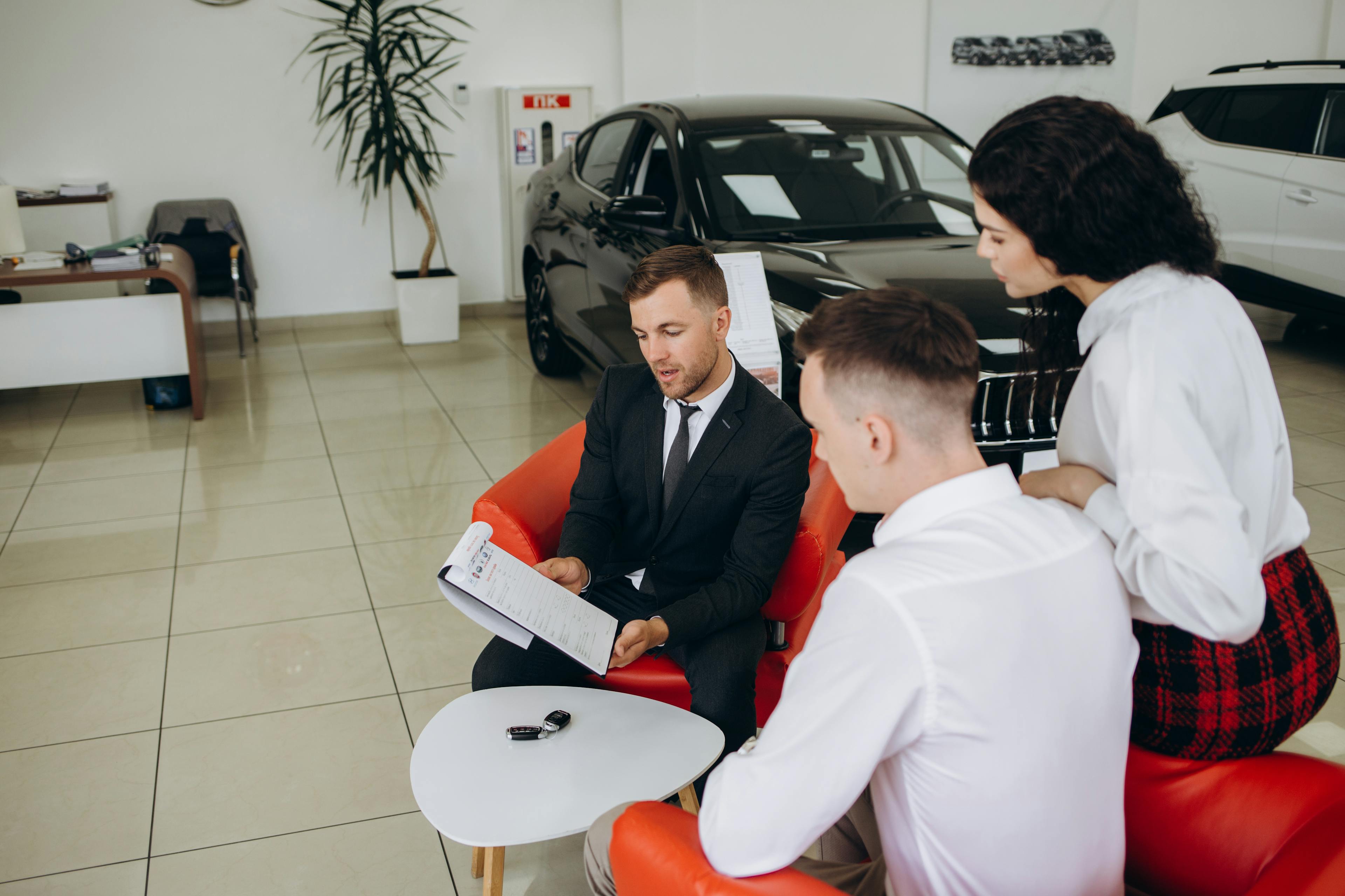 Car dealer explaining finance options to customers