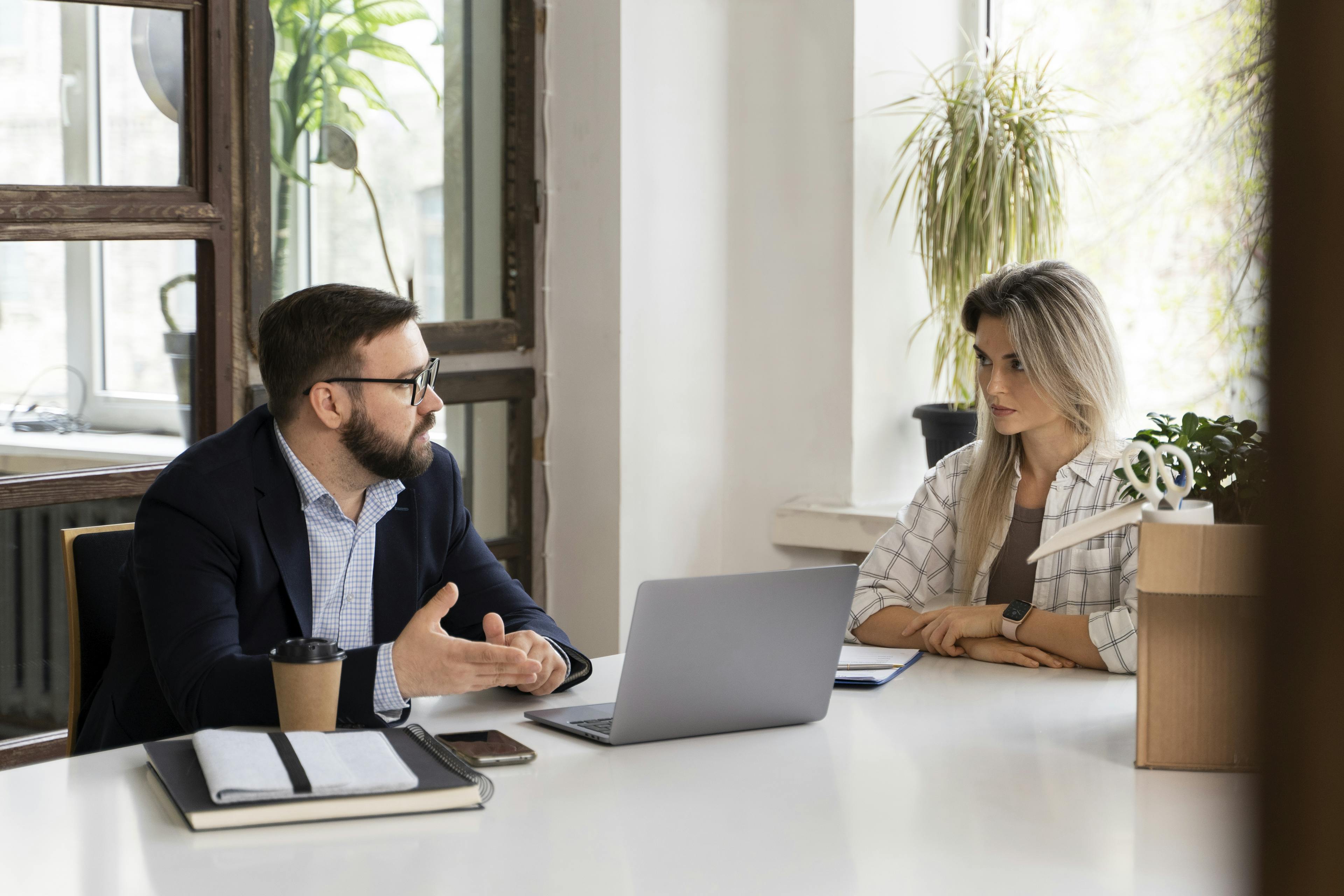 Two colleagues discussing eligibility checker for car finance