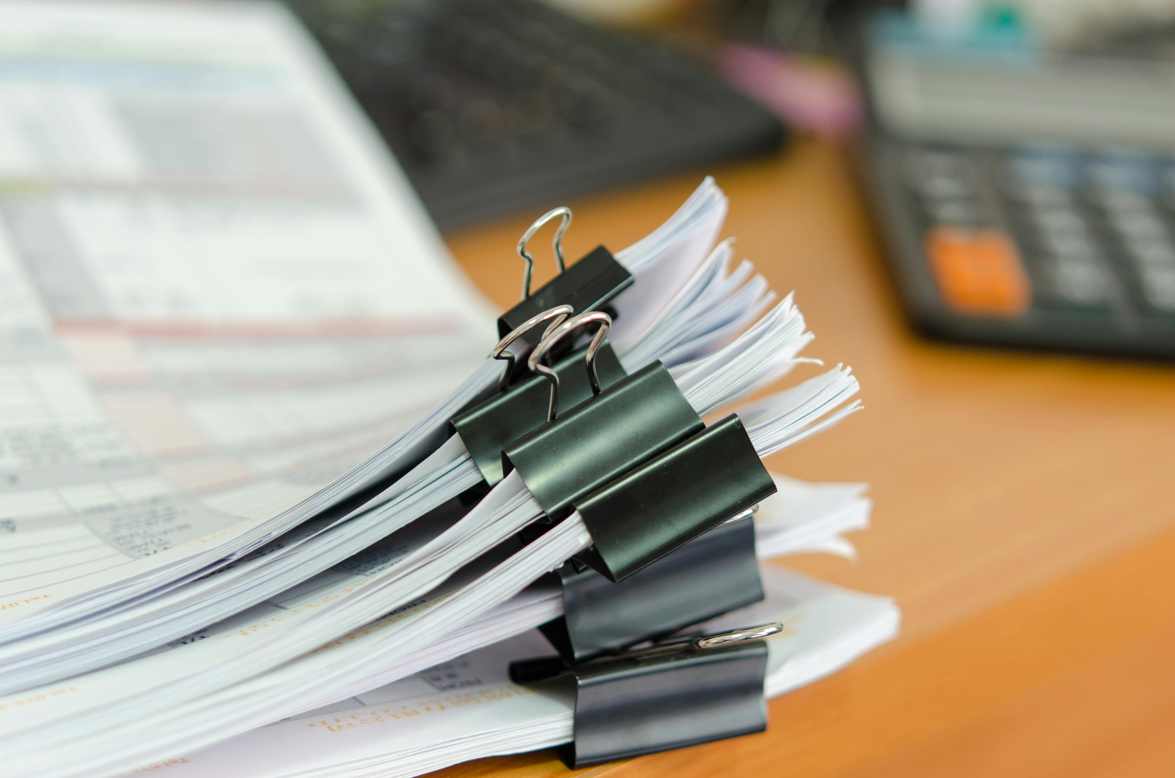Close-up of papers for car finance refund claim stacked on table