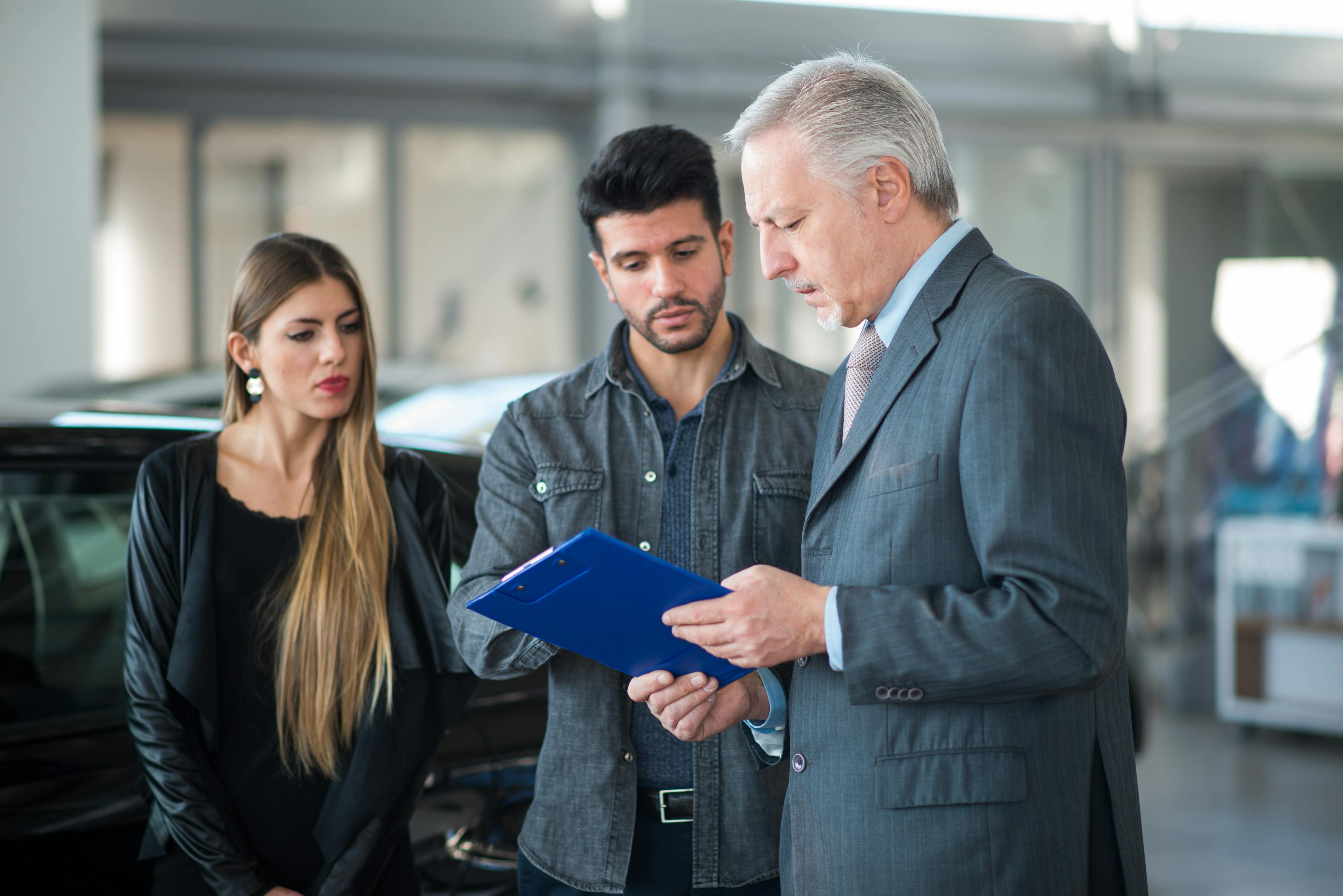 family asking about car finance refund to a salesman