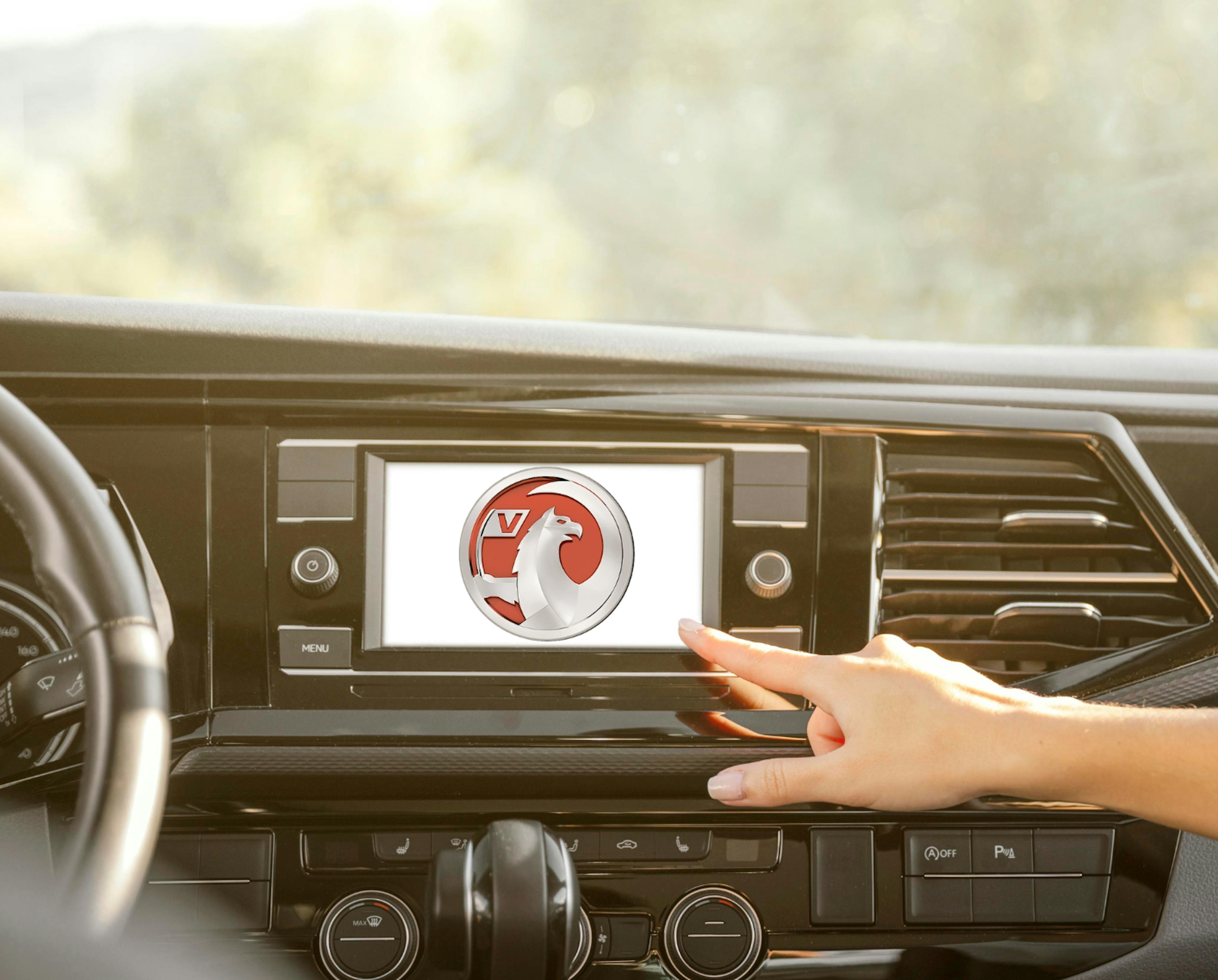 A car infotainment screen displaying the Vauxhall logo