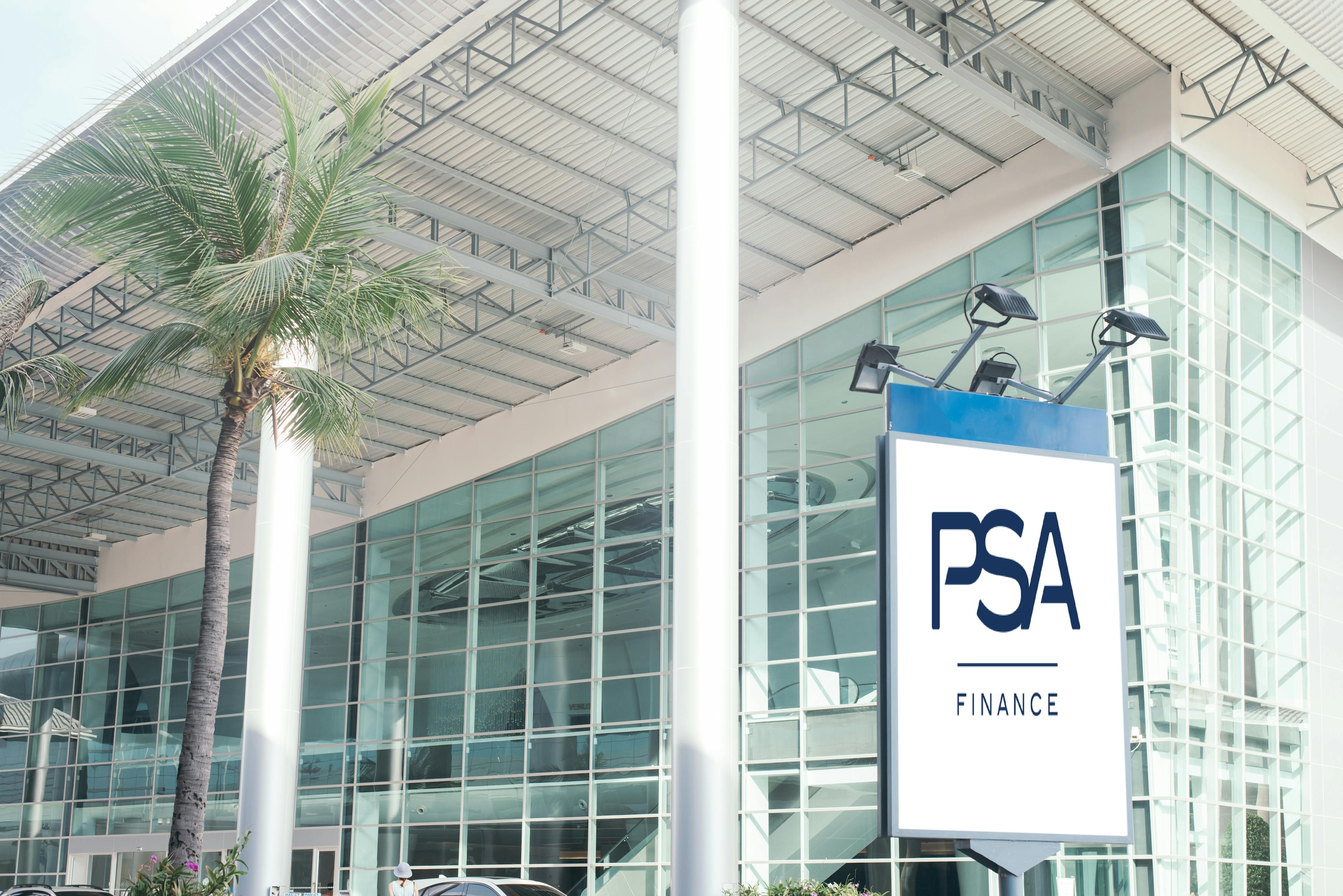 Modern glass building with a PSA Finance sign in front
