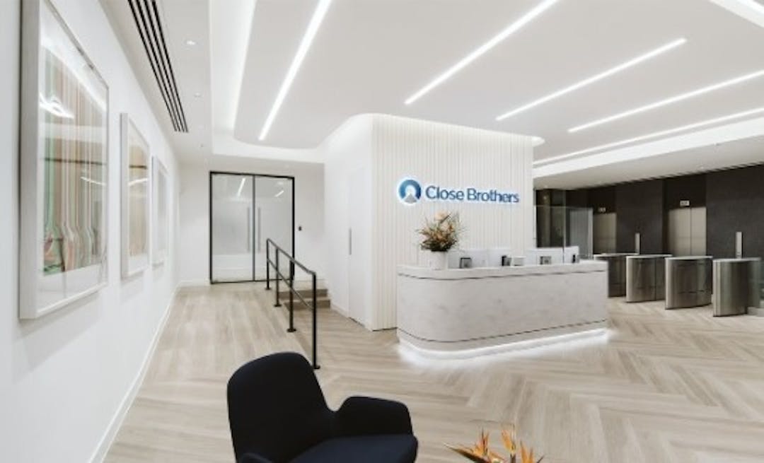 A corporate interior with the Close Brothers logo behind the reception counter