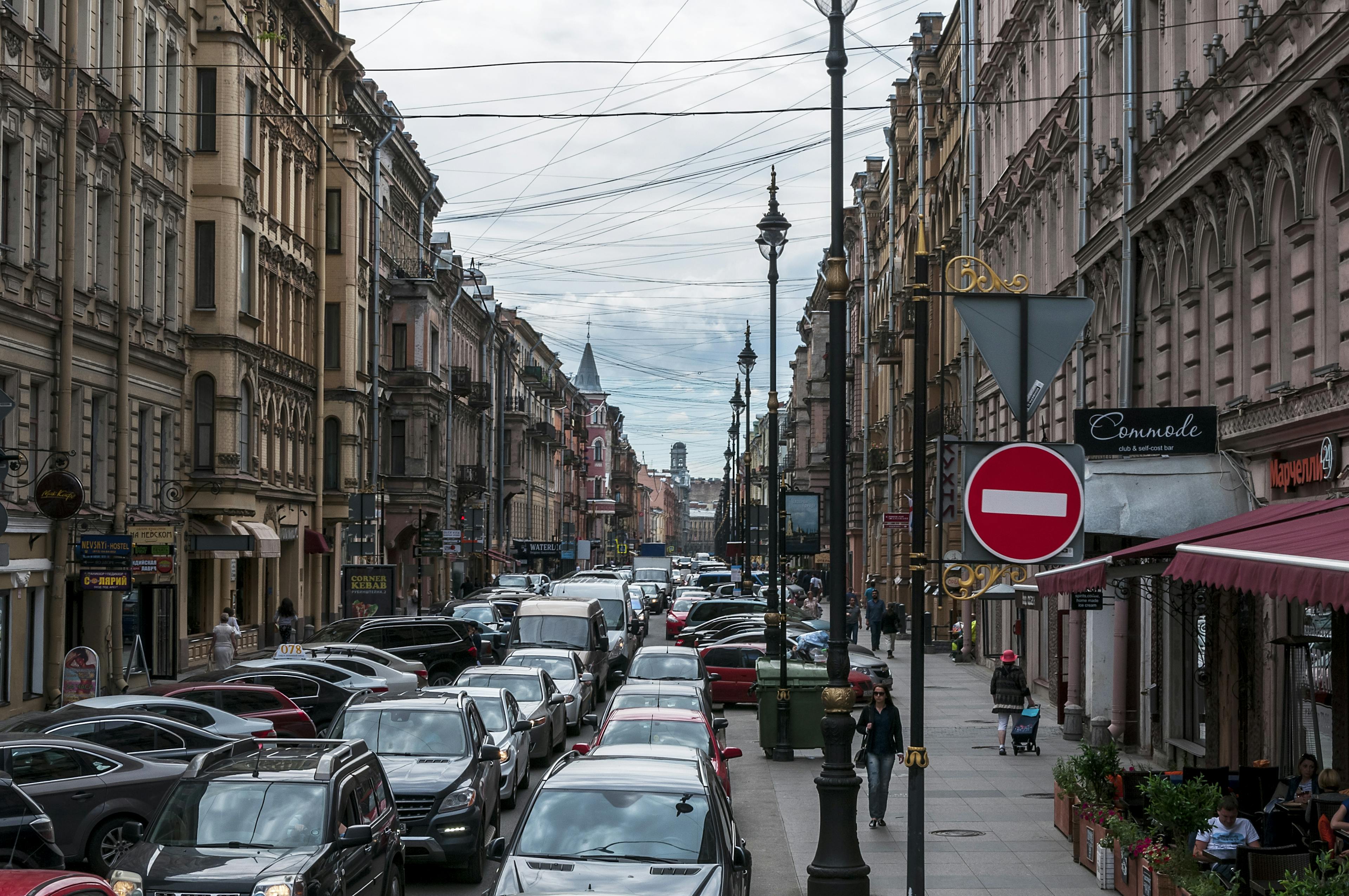 Urban street with dense traffic between historic buildings