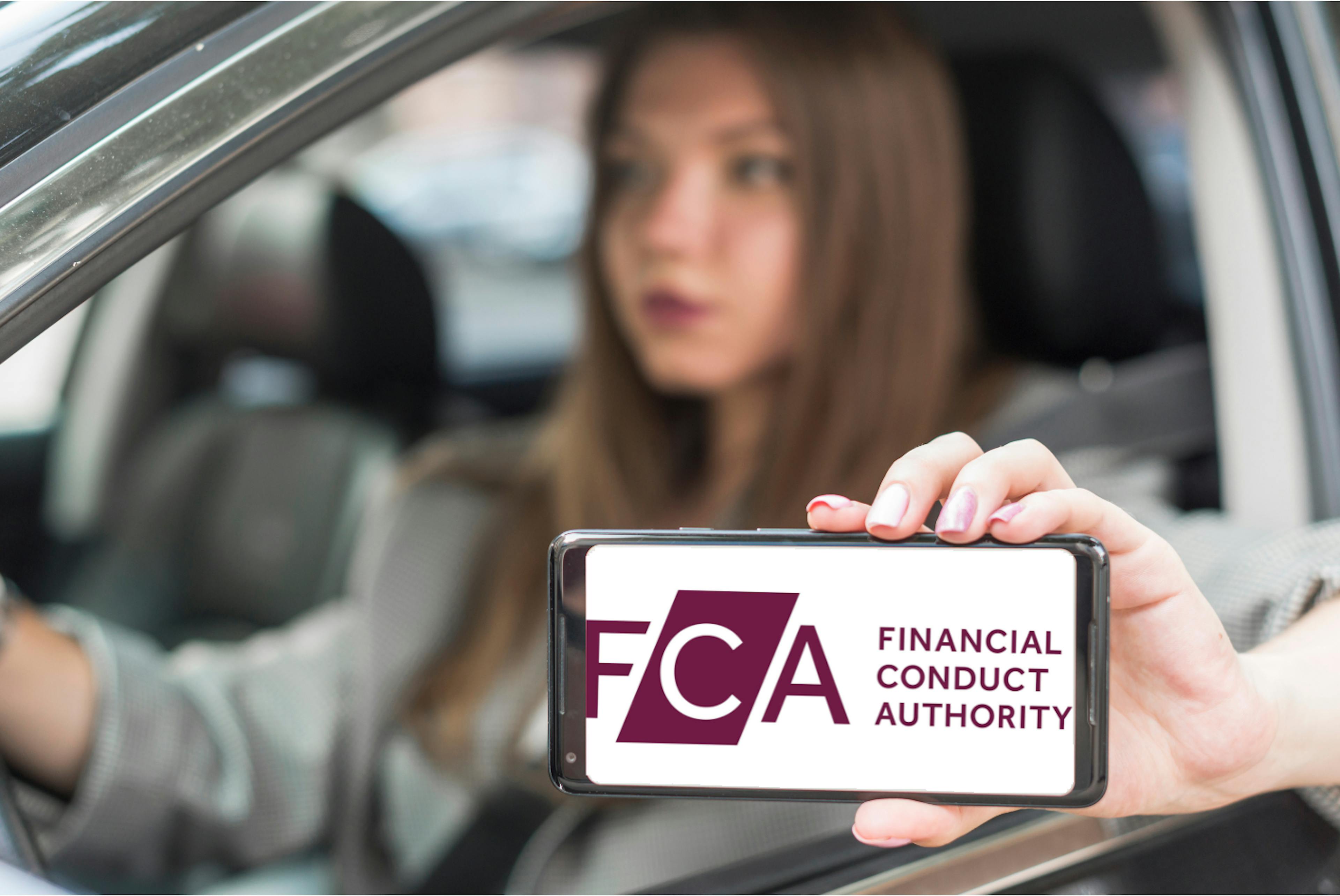 Driver holding phone with FCA logo