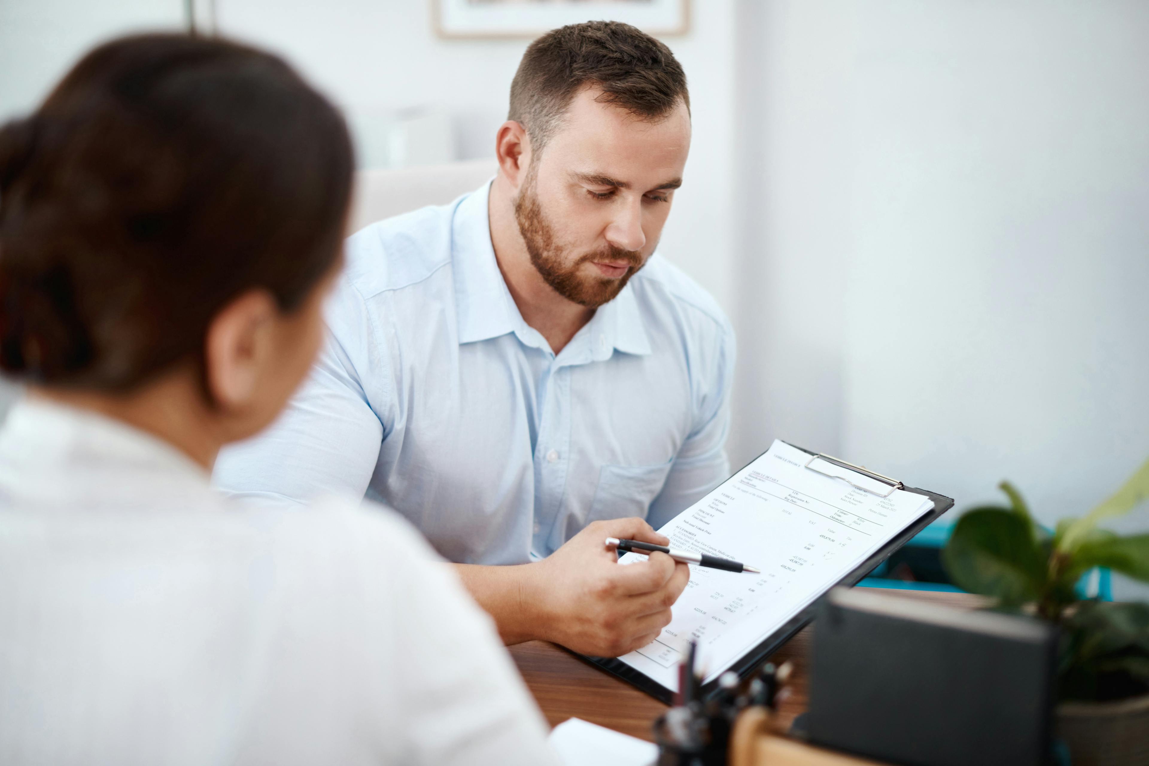 Advisor discussing documents with client on PCP Mis-Selling