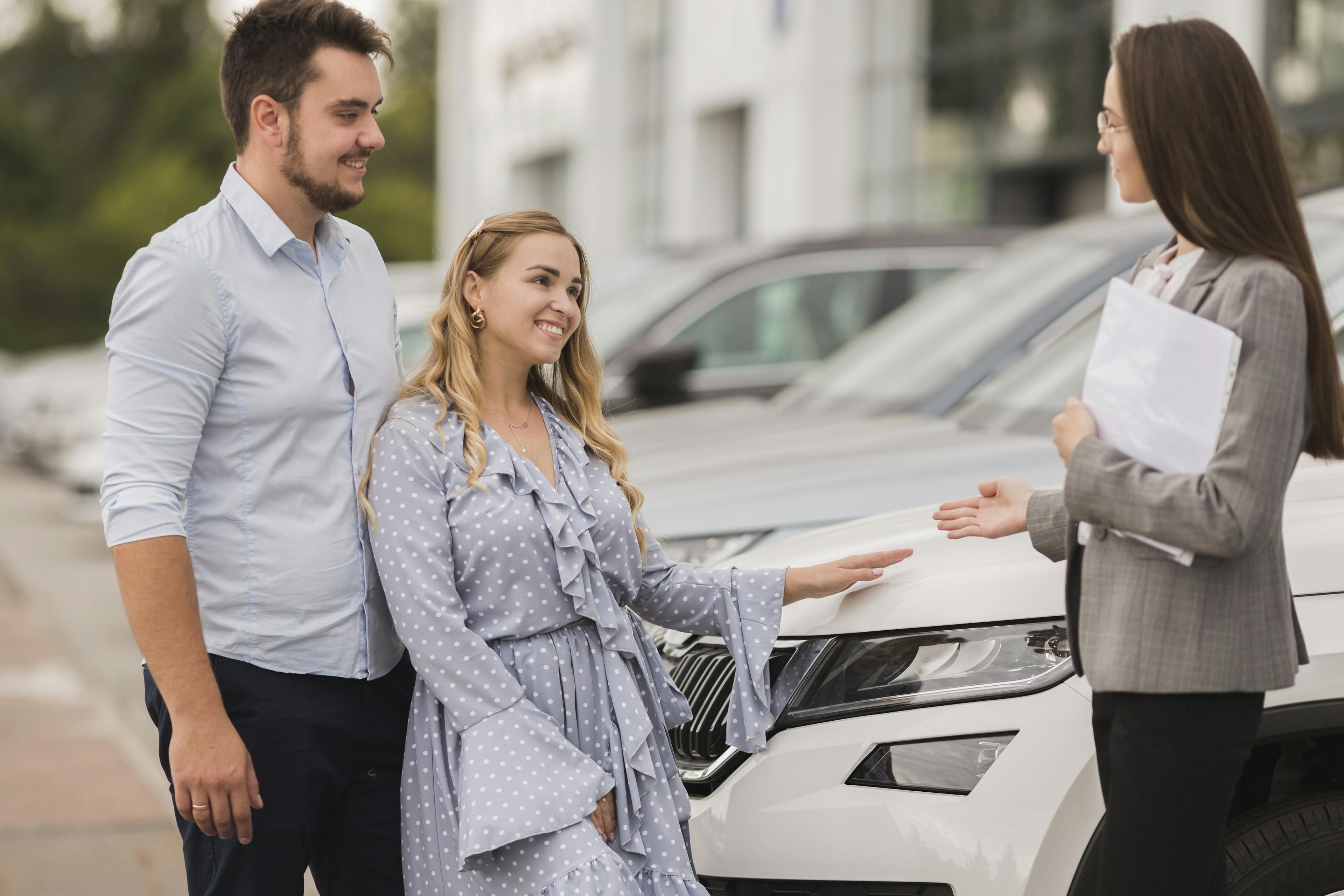 couple talking to a female car dealer