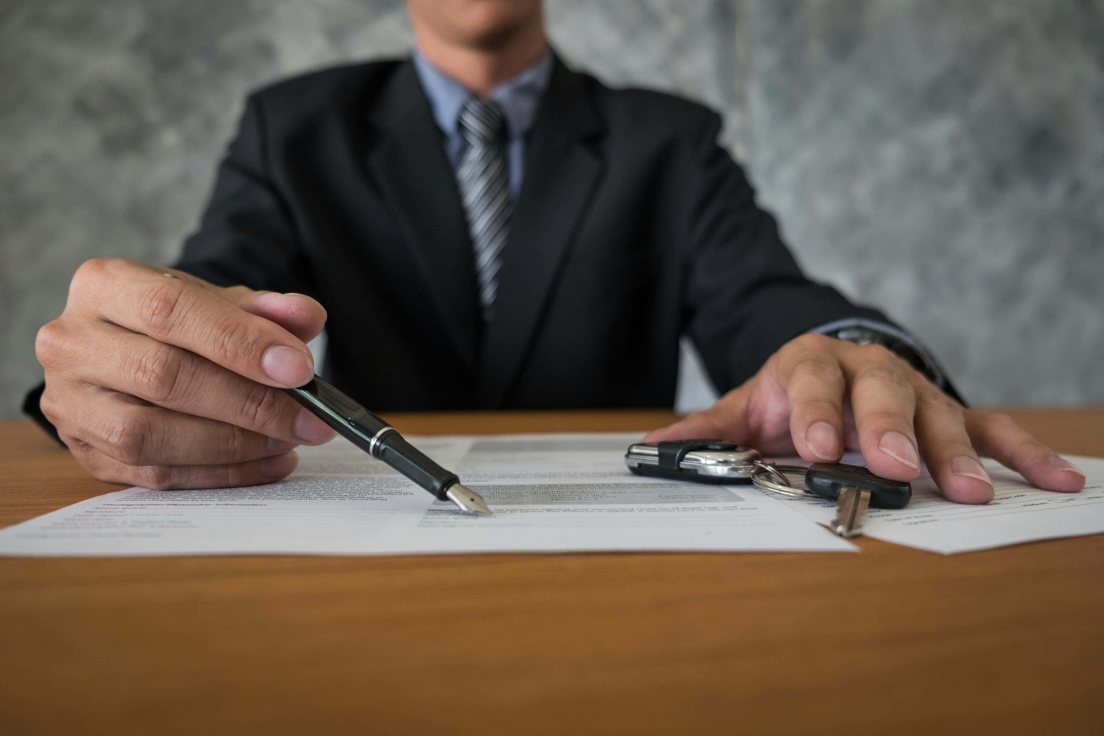 lawyer with car keys and contract on a table