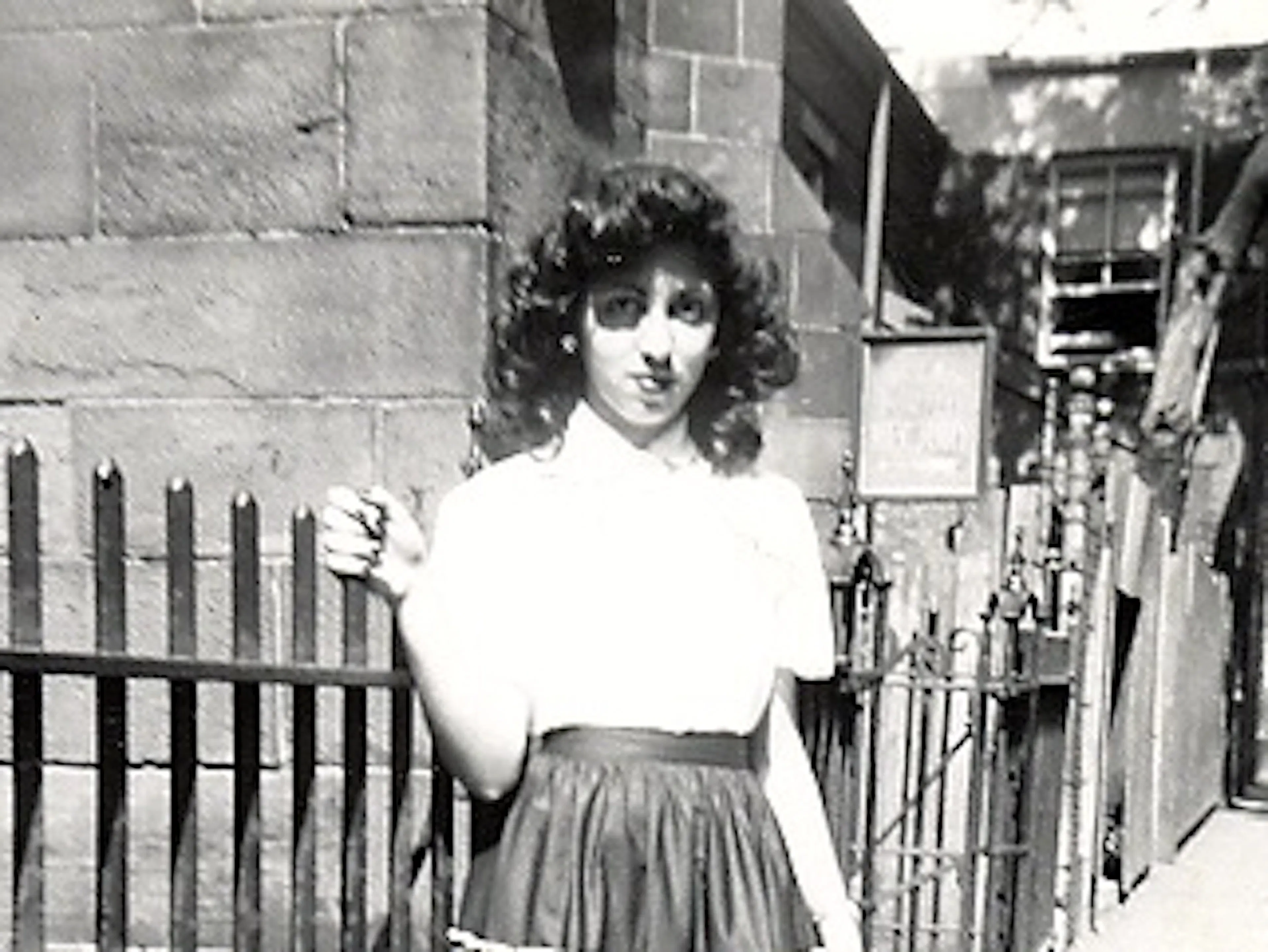 Gloria by fence, 1950s.