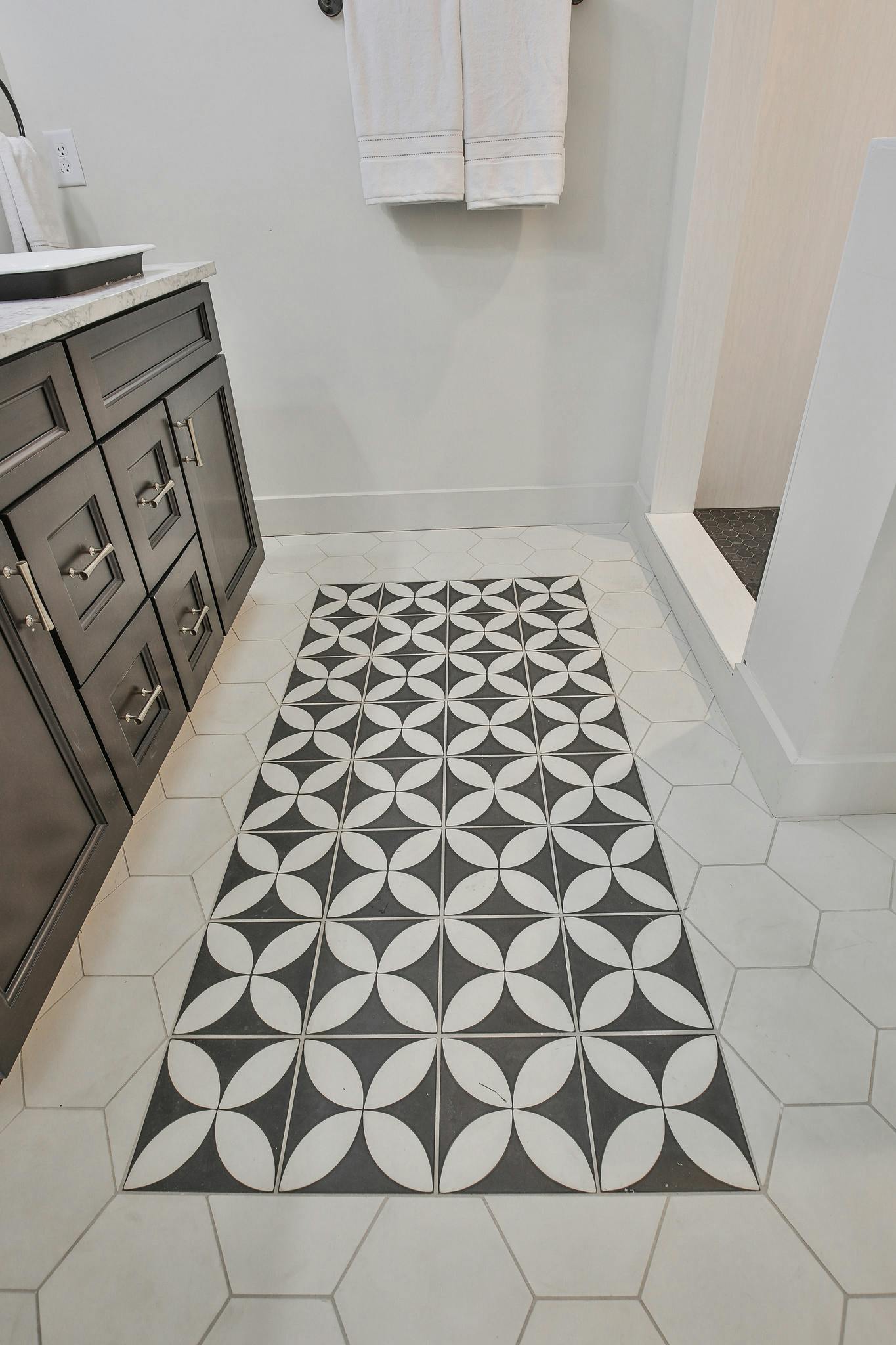 Sinks/Faucets/Shower Hardware: Kohler, Tile Floor: Cement Tile Shop, Shower surround and counters: Hanstone Quartz, Drawer Pulls: Liberty Hardware, Lighting: Savoy House, Vanity: Forevermark Cabinetry