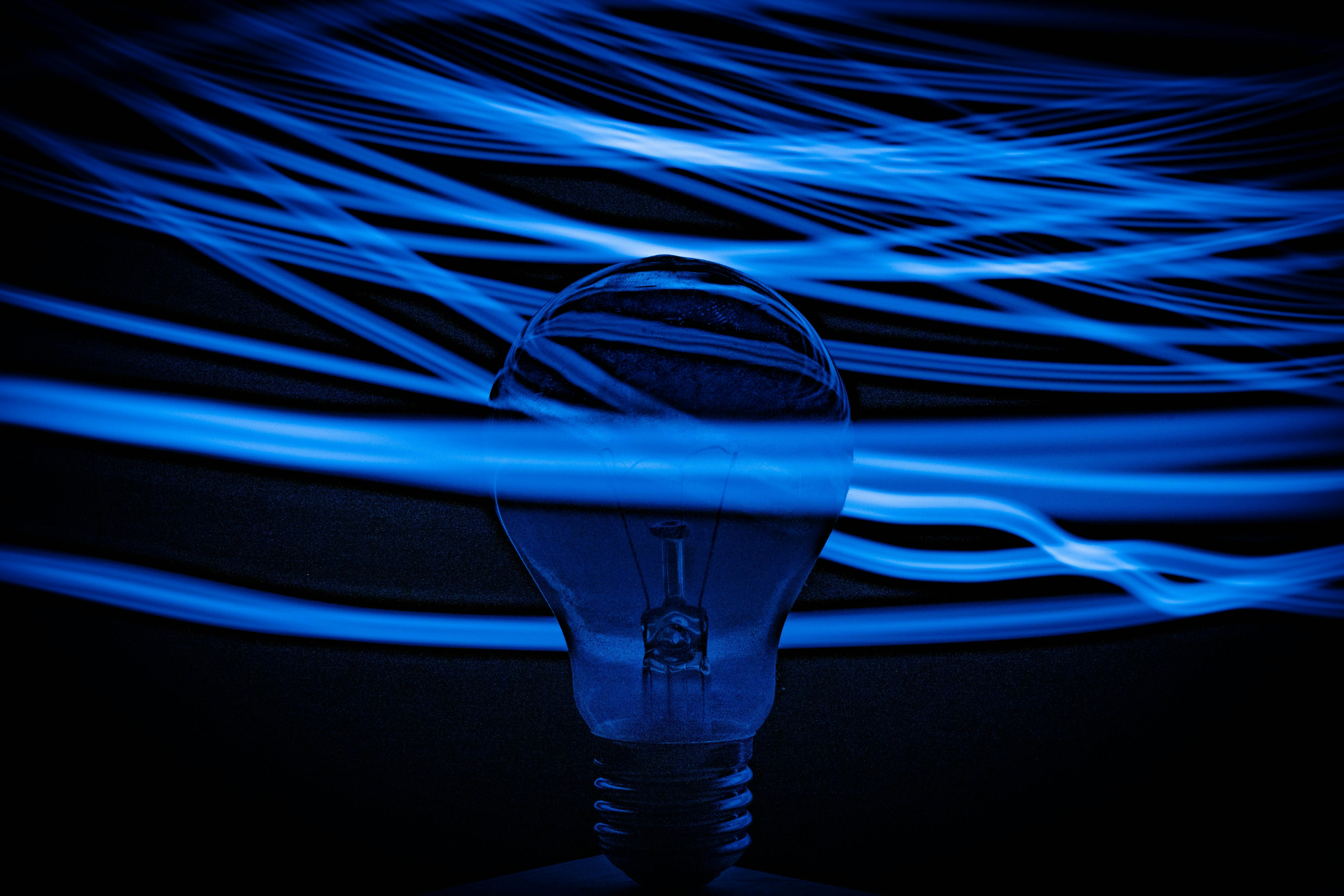NRF Expo 2023 - Key insights. A lightbulb in a dark room, surrounded by neon blue lights