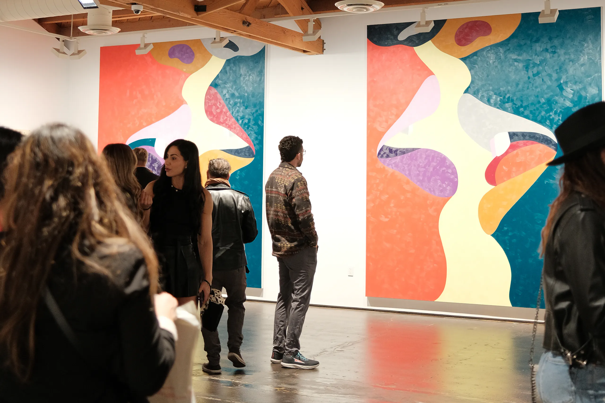 person looking at wall art