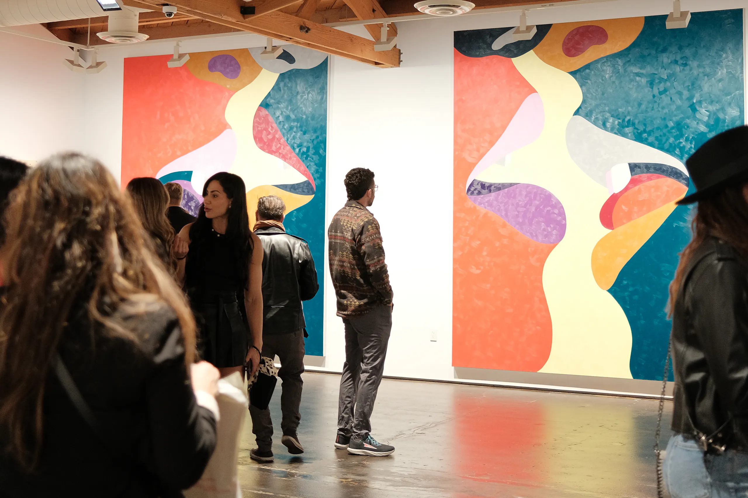 person looking at wall art