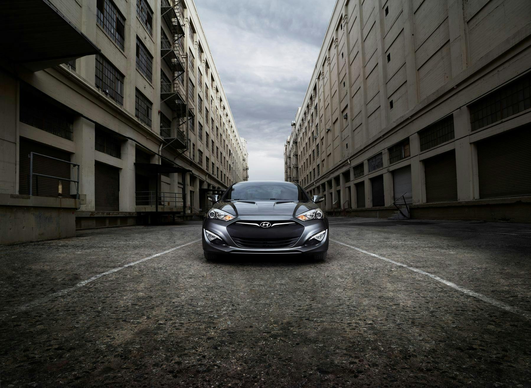 front on image of a car between buildings