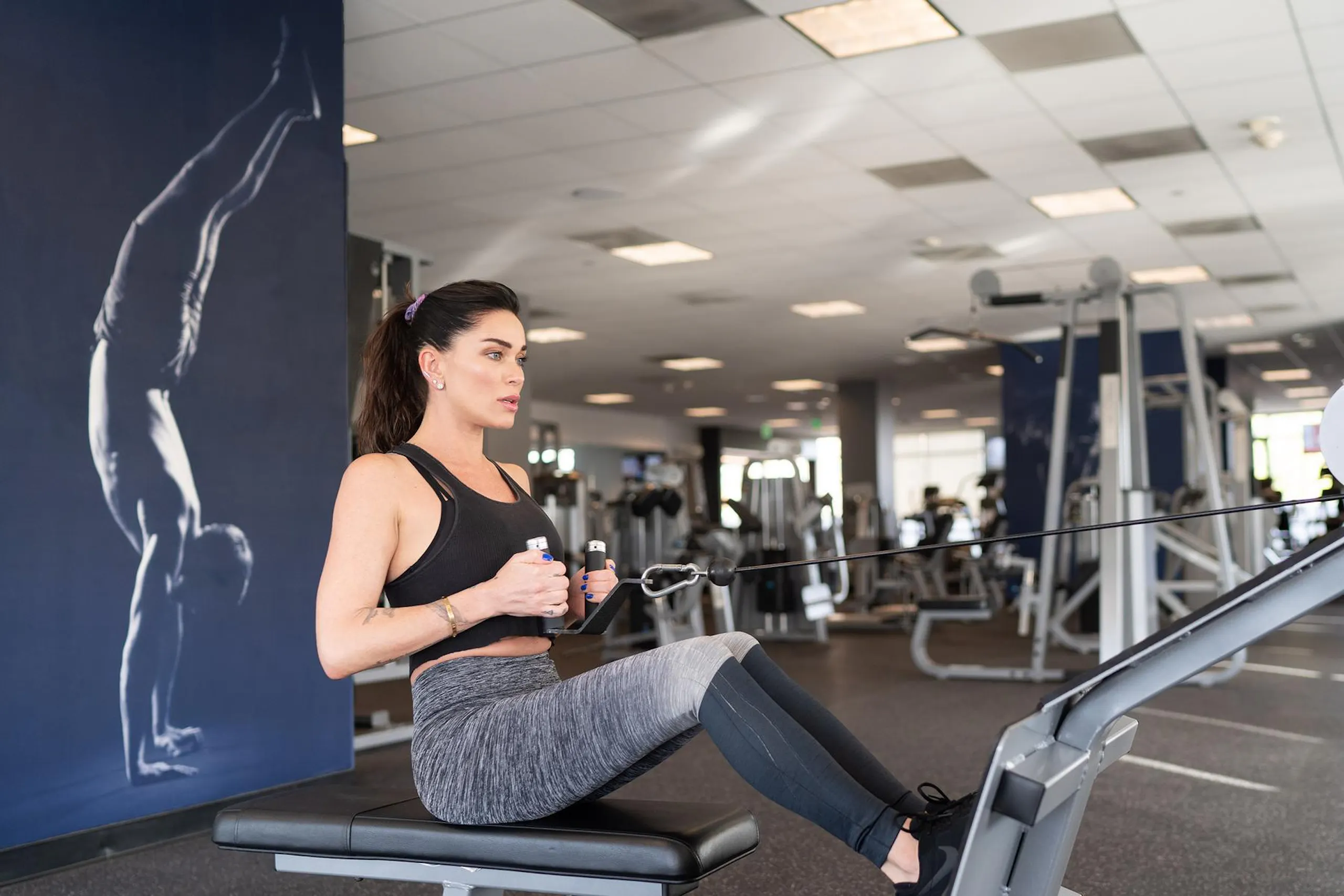 woman rowing in gym area