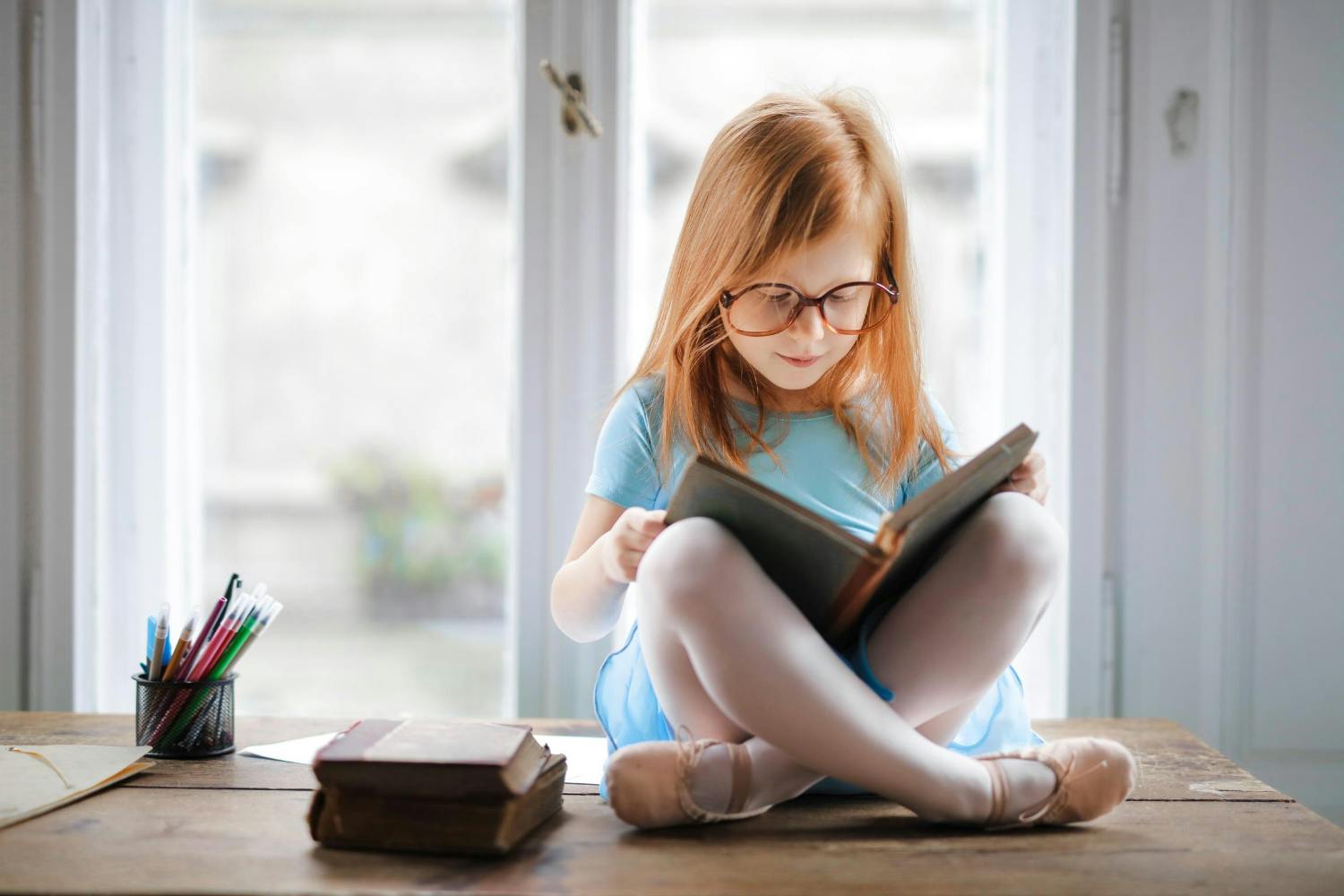A young girl reading a book