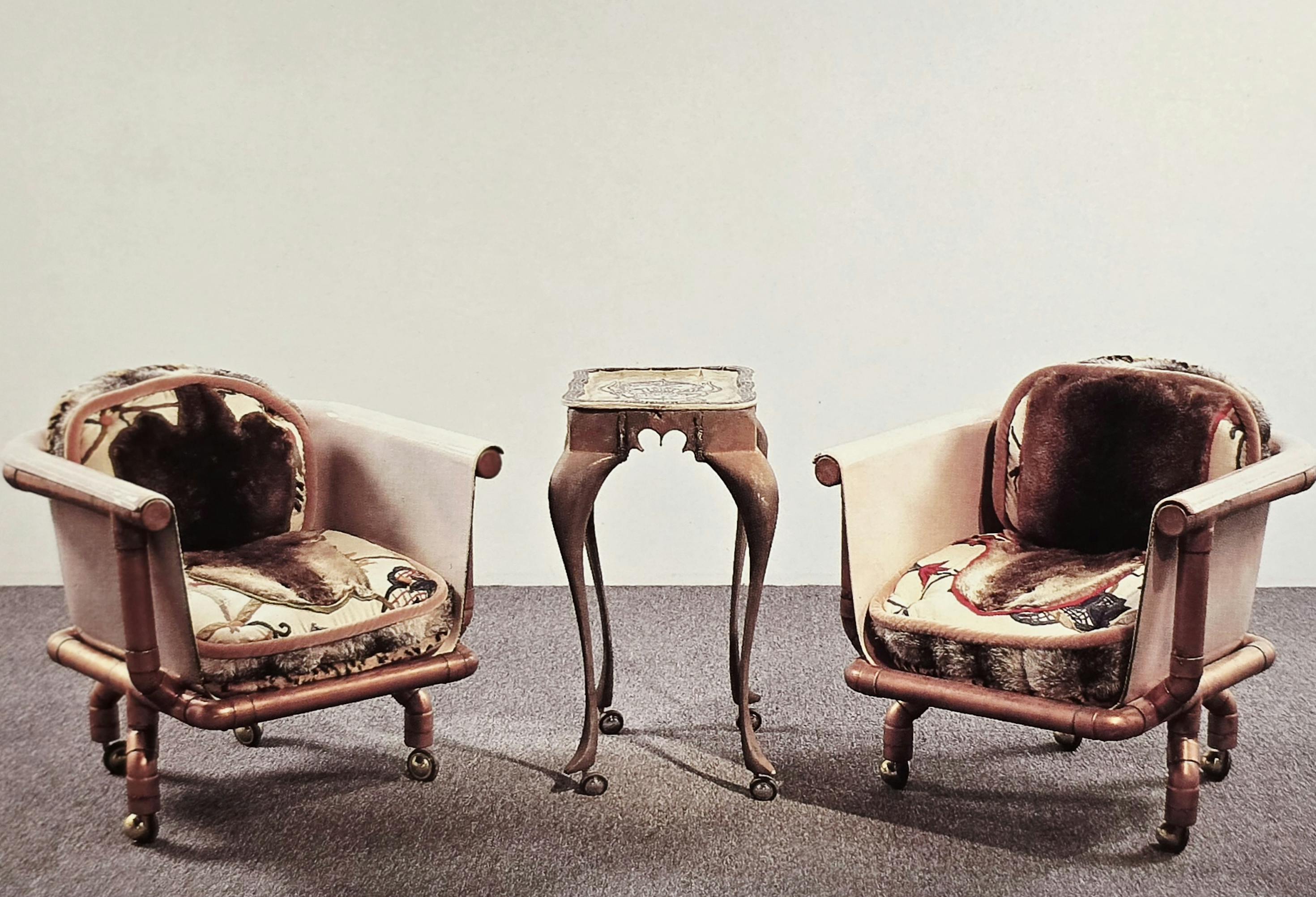 Endangered Species Chair I & II, 1992, Enameled cast iron, copper plumbing pipes and fixtures, upholstery including crewel, embroidery, otter fur, and fake fur, each 32 x 30 x 27 inches Motorhead Tray Table, 1992, Vitreous china, cast iron, and wheels, 30 x 21 x 16 inches