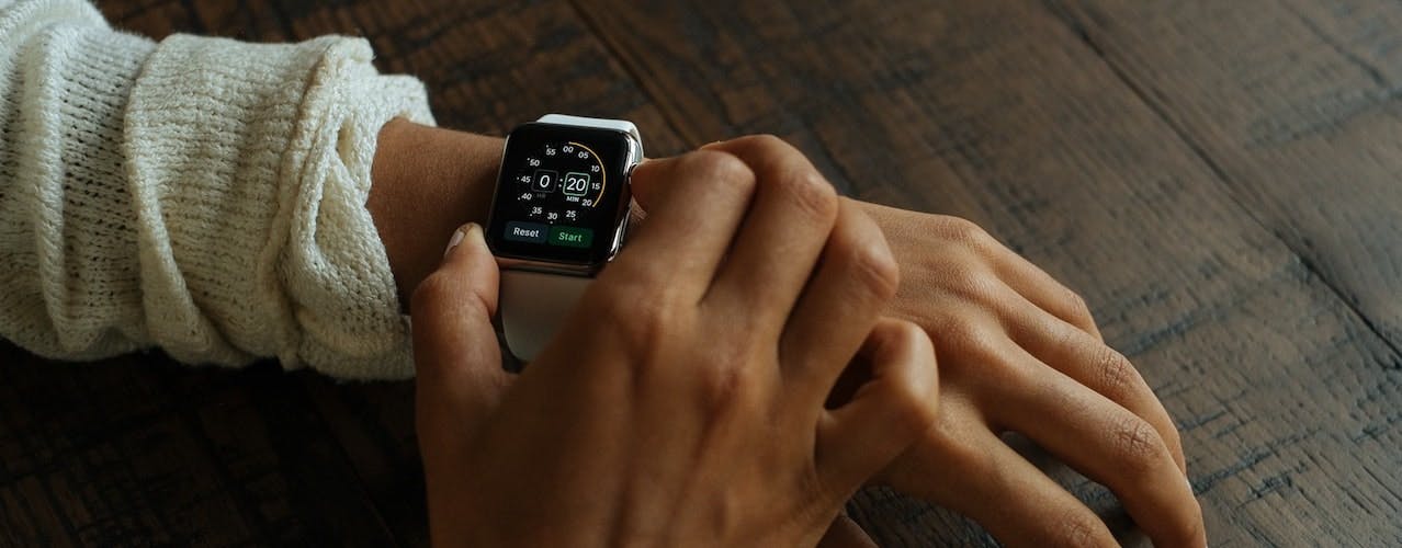 Person setting time on digital watch