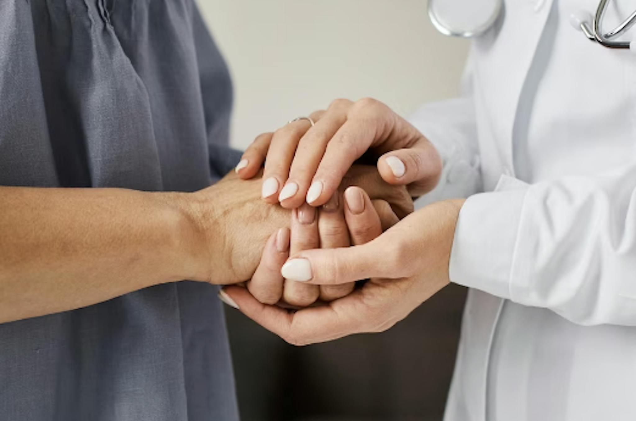 doctor holding a patient's hand