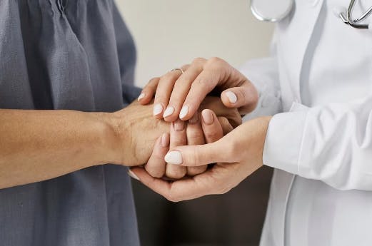 doctor holding a patient's hand