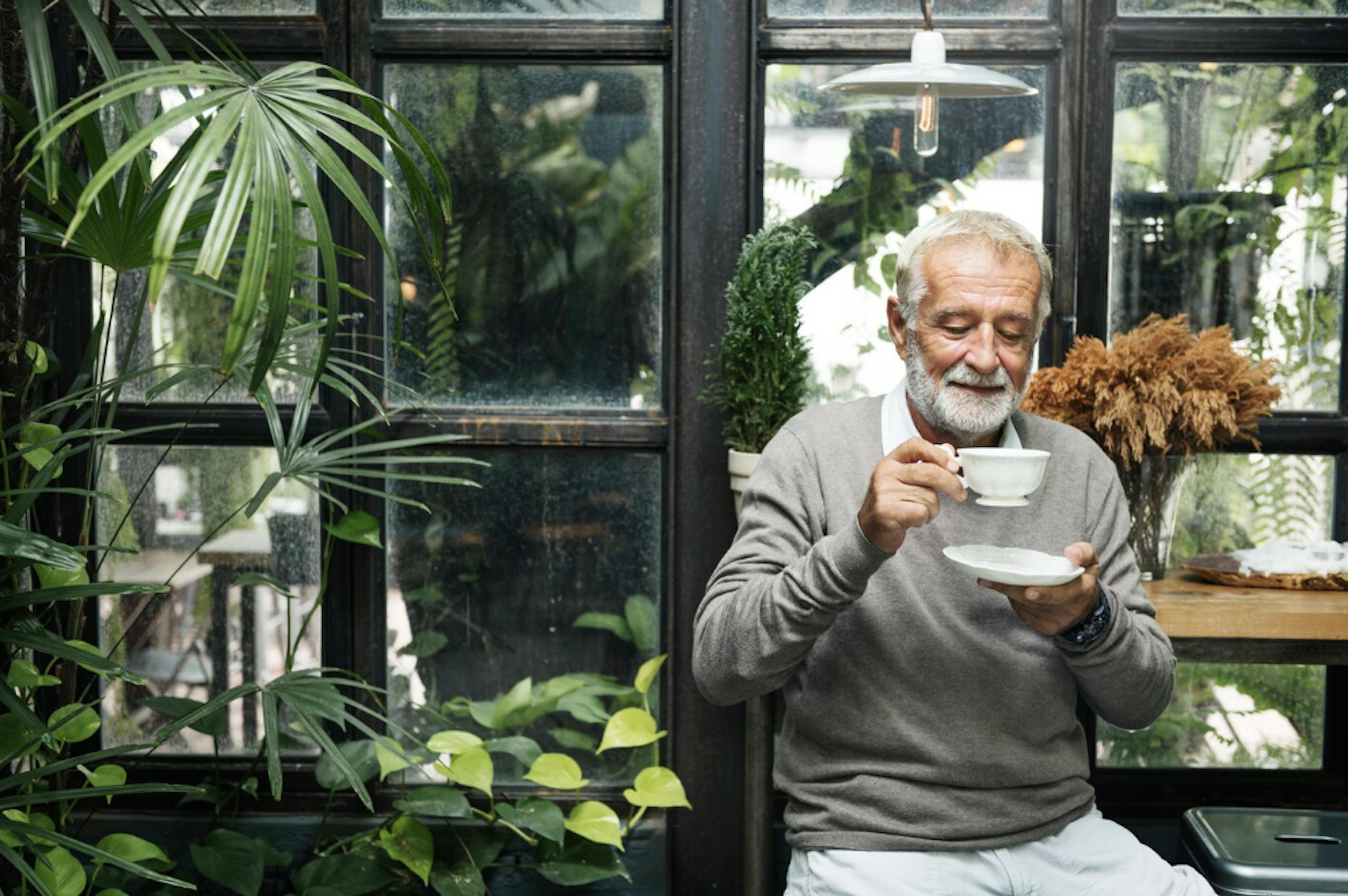 Old man sipping on tea