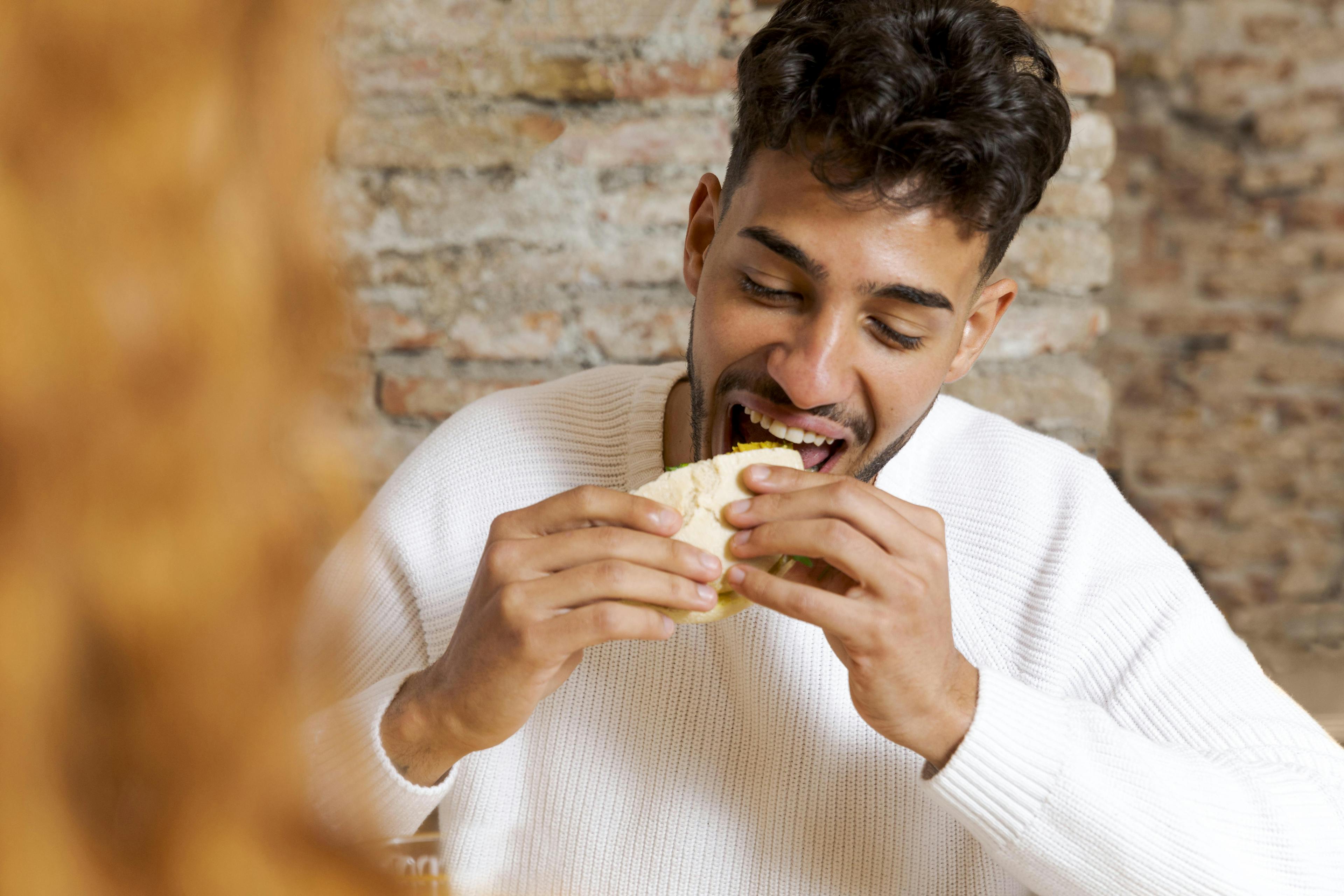 Close up happy man eating food