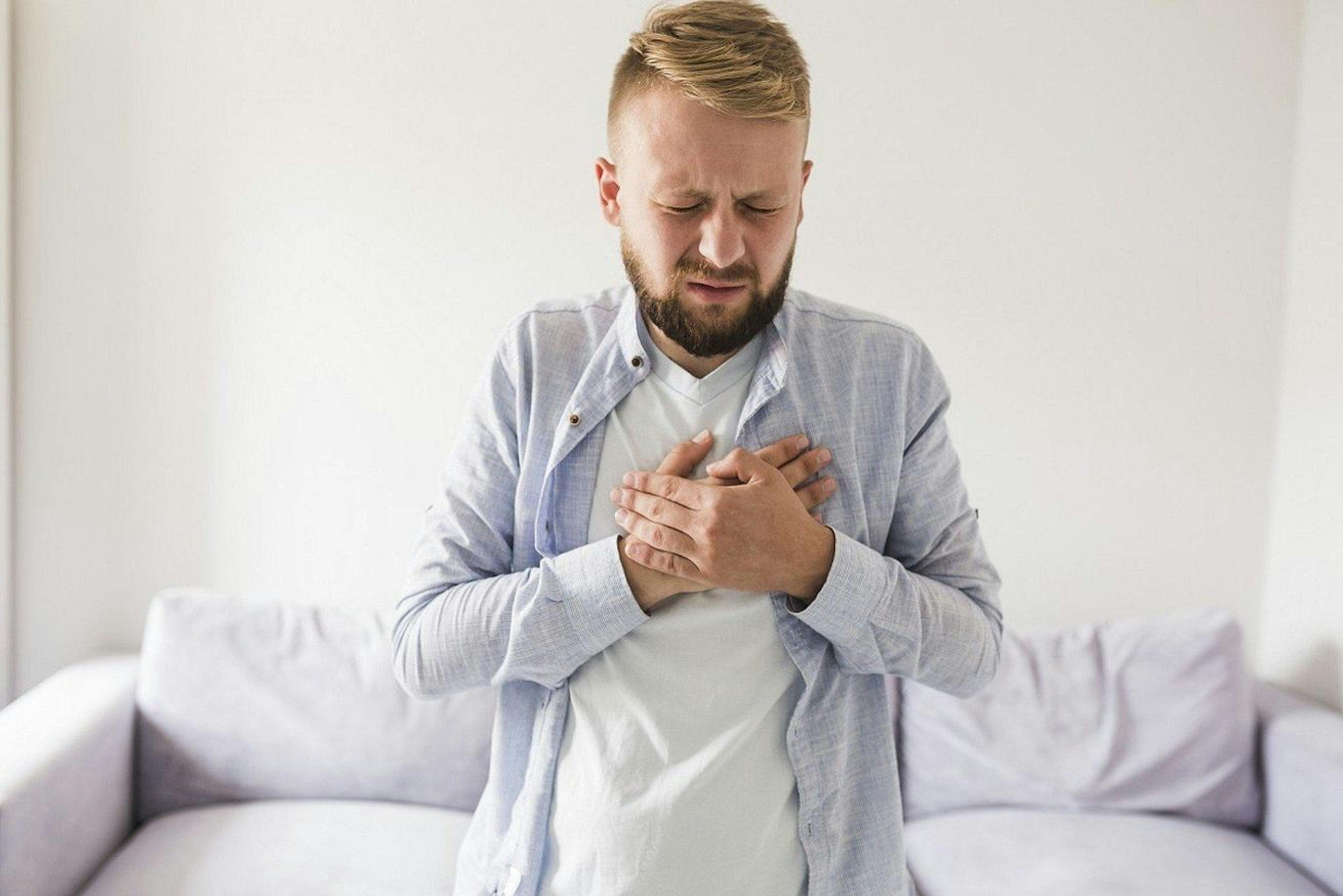 man clutching his chest in pain