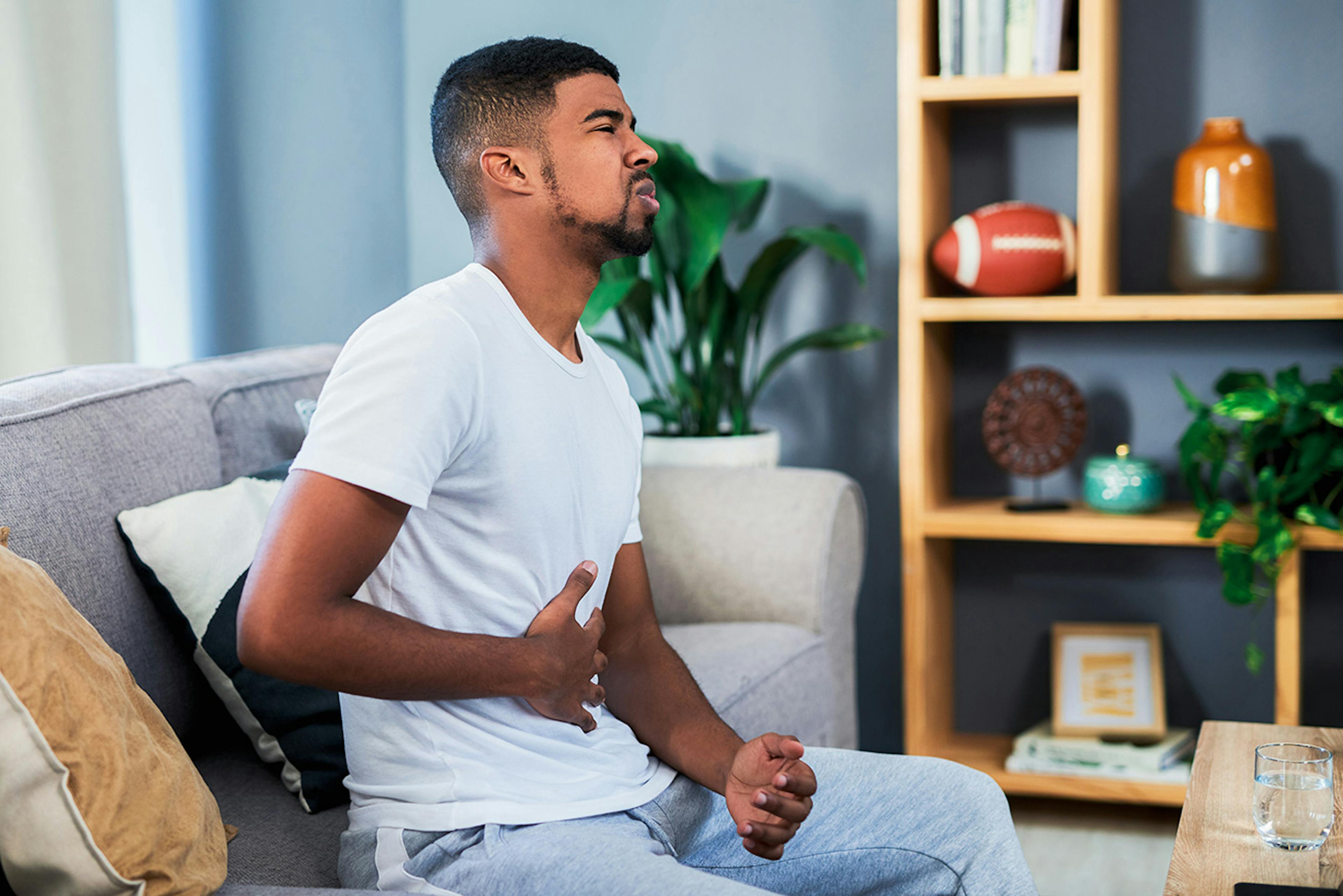 man holding his stomach in pain