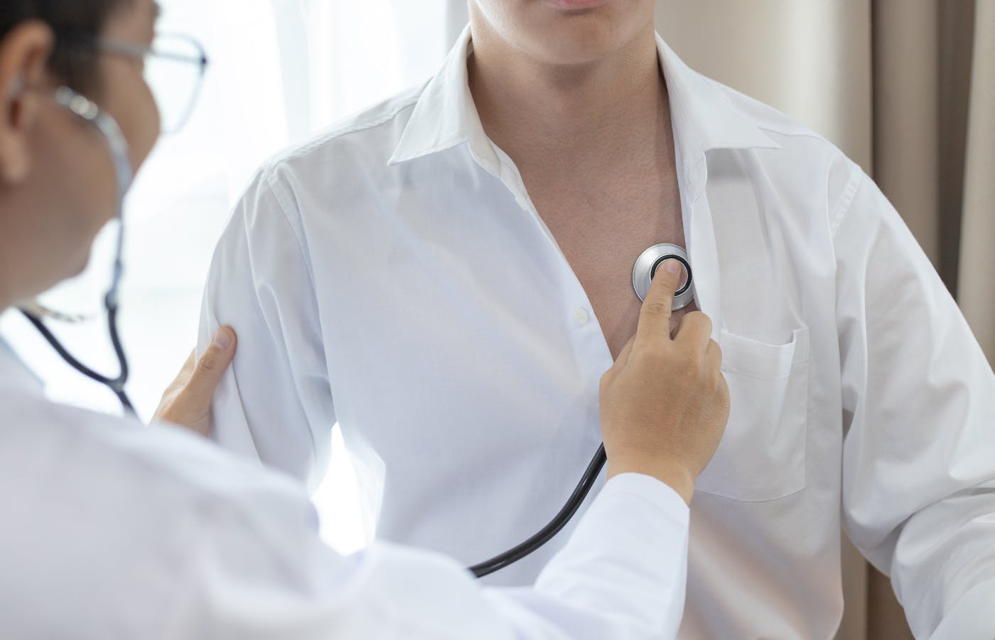 doctor examines a patient with a stethoscope