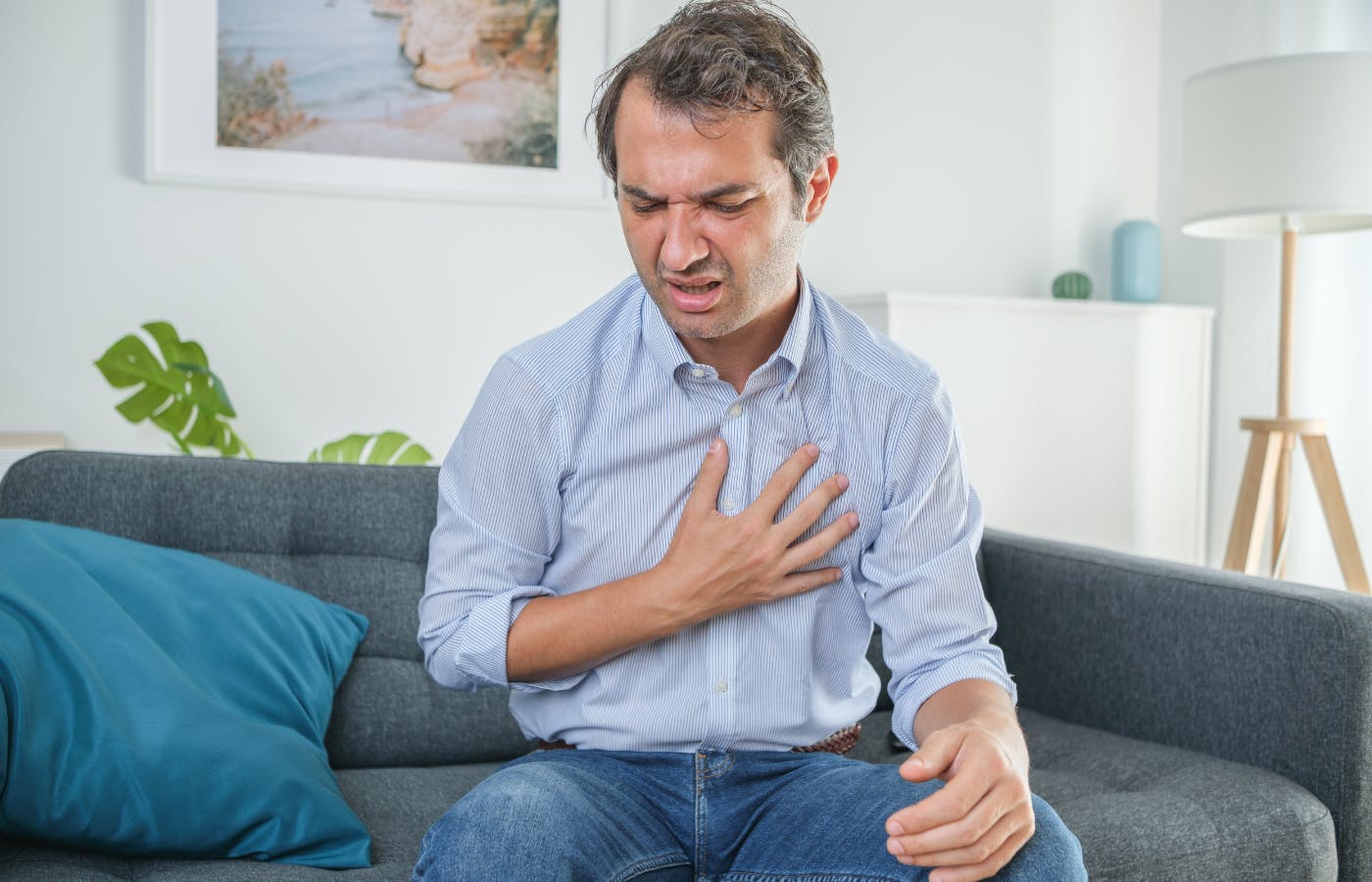 man clutching chest