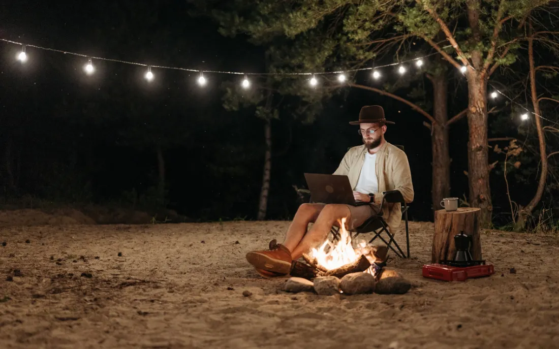 Man sitting with computer by the fire