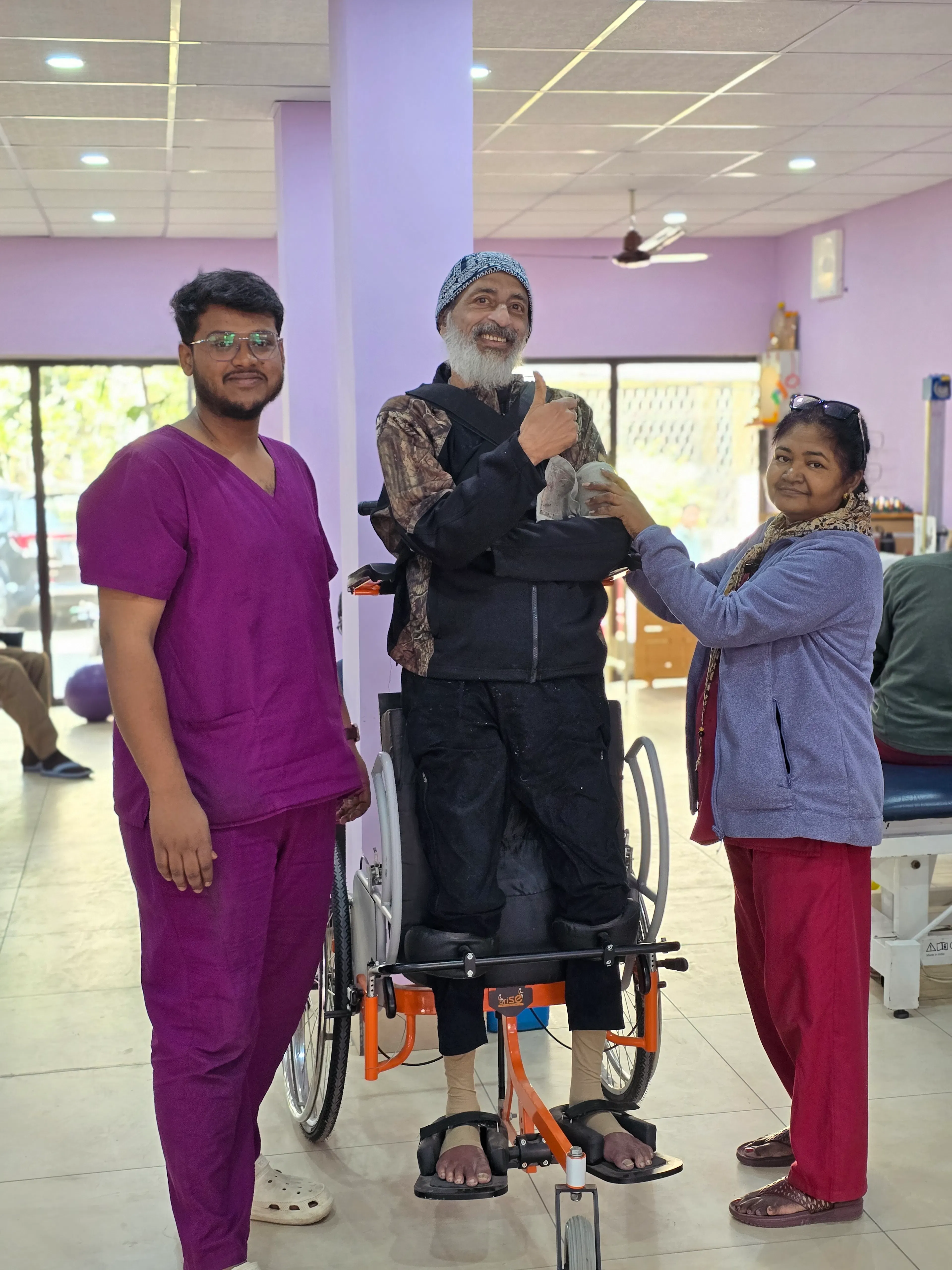 Man standing in a robotic gait trainer with two therapists beside him during robotic rehabilitation