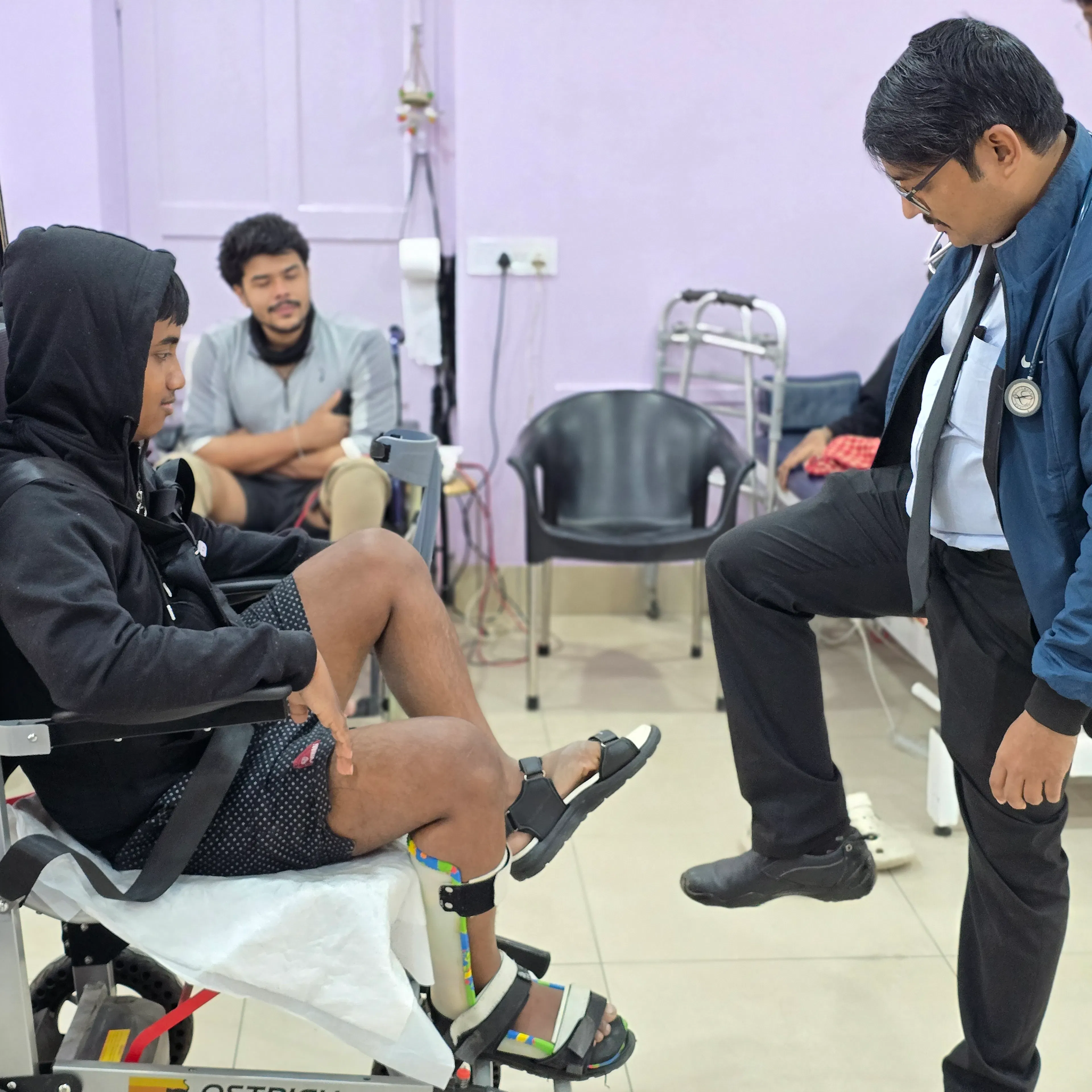 Patient using a robotic standing and gait device while a doctor observes