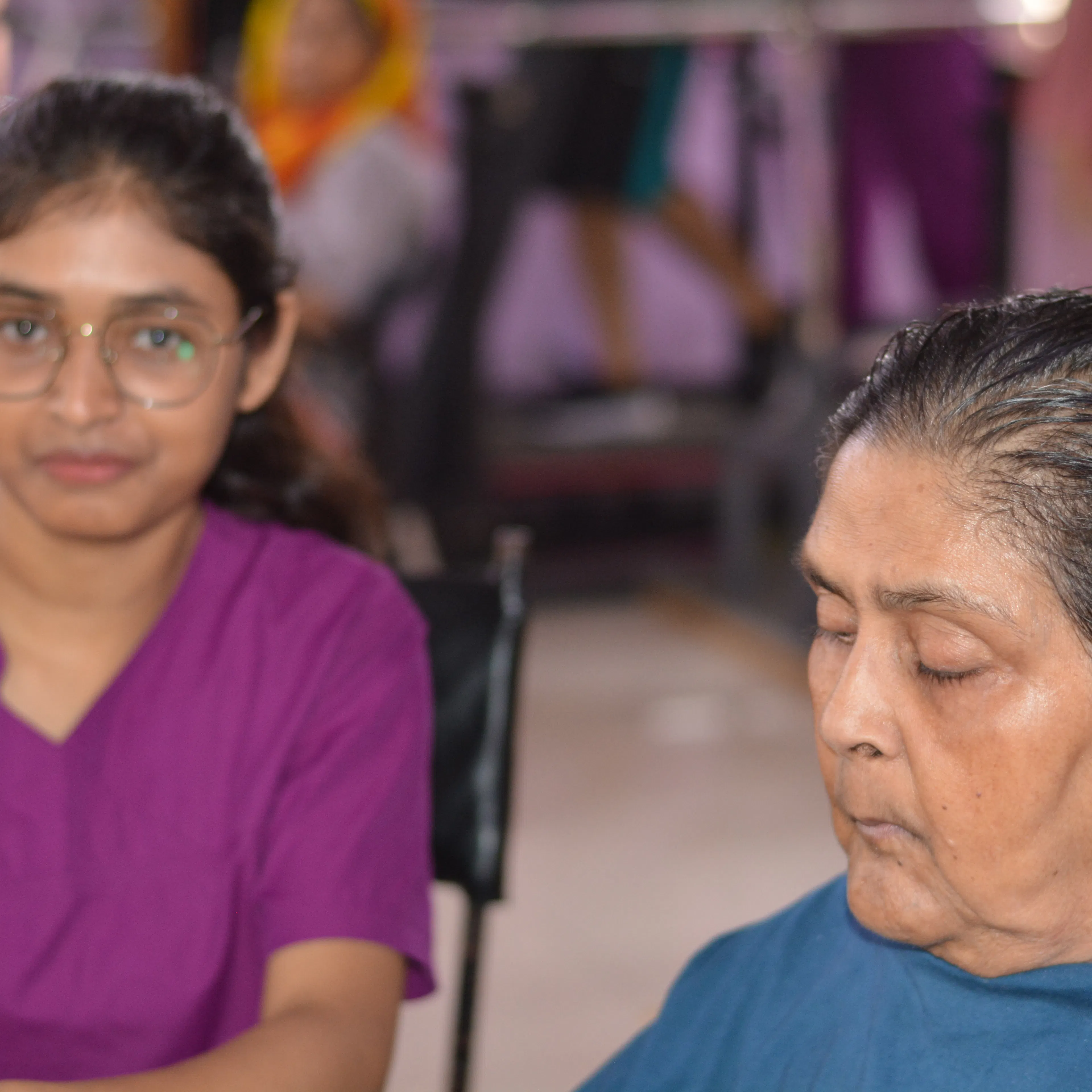 Therapist sitting beside an older woman to talk through how the garden therapy session felt