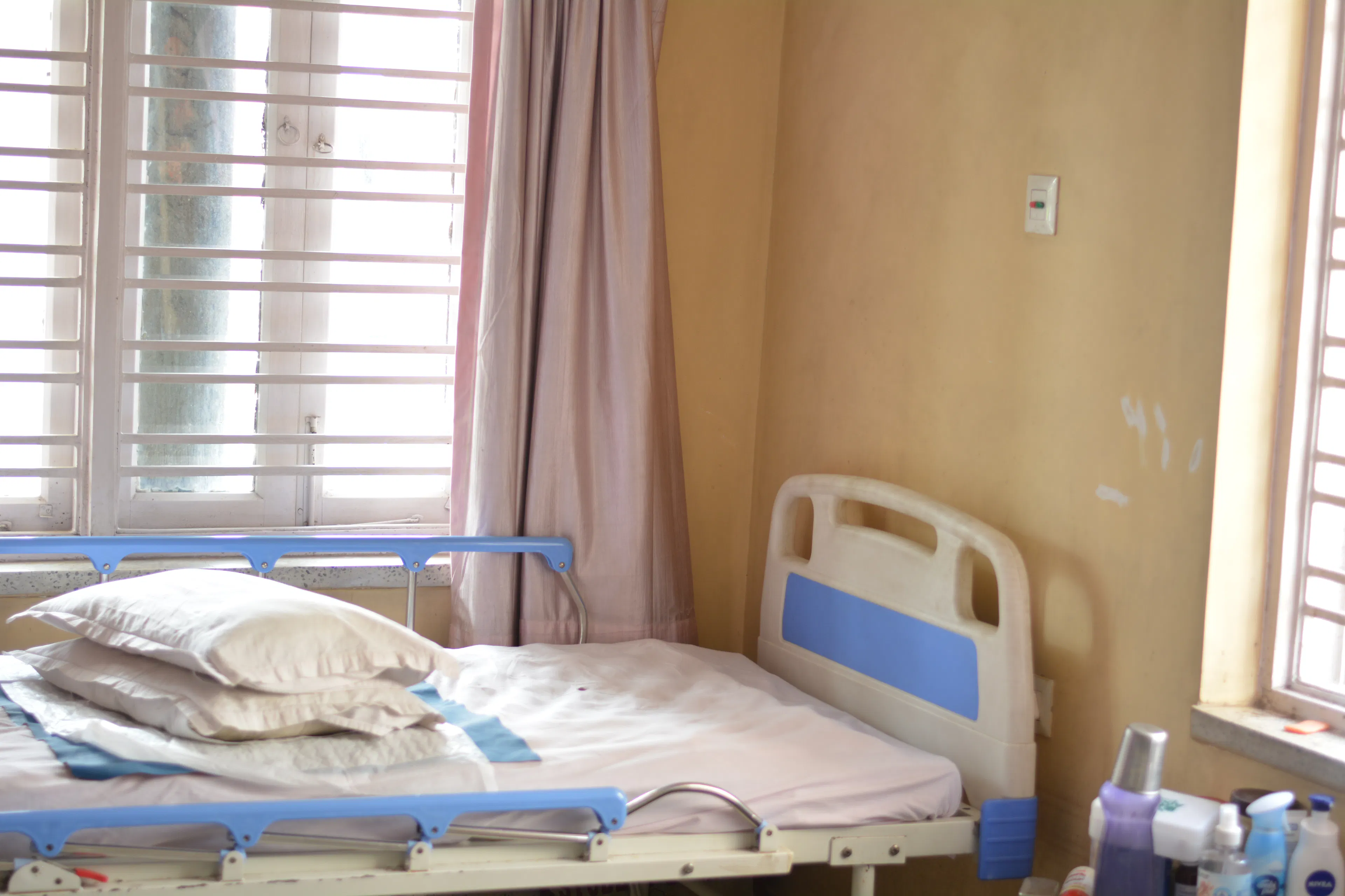 Bright patient room with hospital beds by the window at a neuro rehabilitation centre for inpatient stays