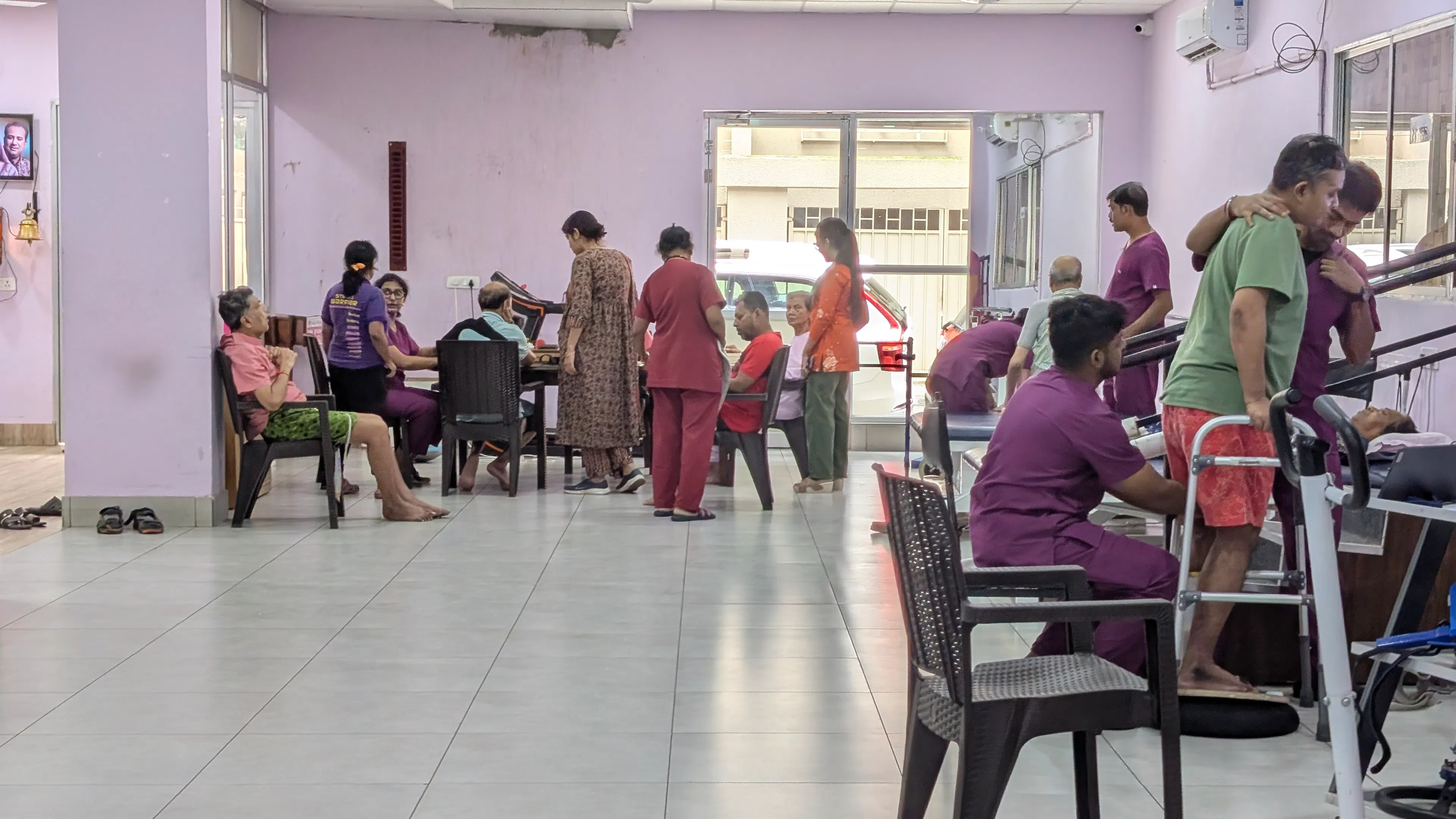 Busy therapy hall with patients and therapists during a day of inpatient rehabilitation