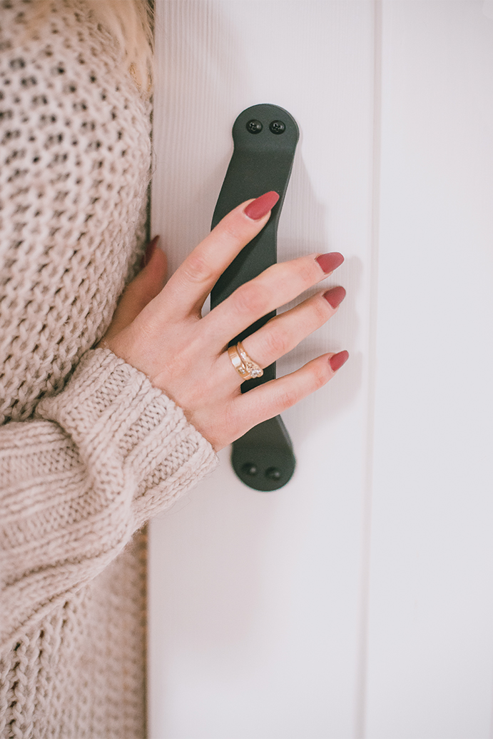 schwarzer Griff an einer weißen Holztür