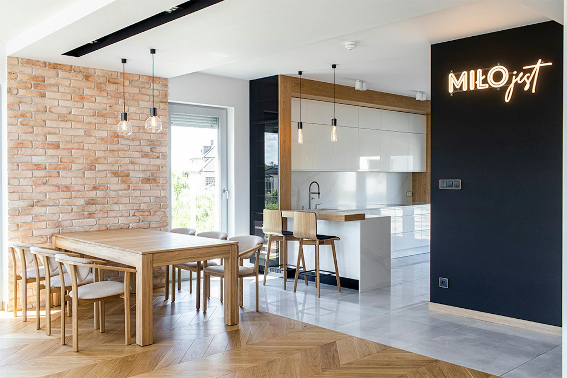 Essecke in der Küche, große offene Küche, Industrielampen in der Küche, Leuchtreklame, weiße Möbel in der Küche, hochglänzende Küchenmöbel