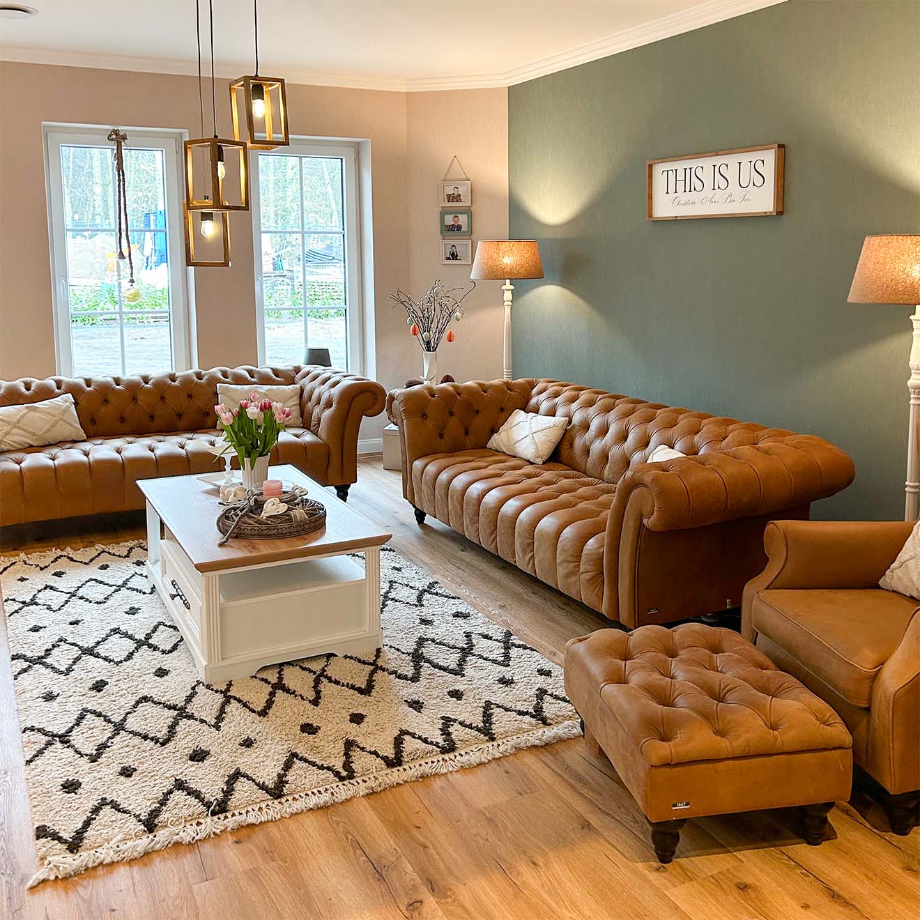 braun gesteppte Sofas und Sessel und ein weißer Couchtisch aus Holz in einer klassischen Wohnzimmeranordnung