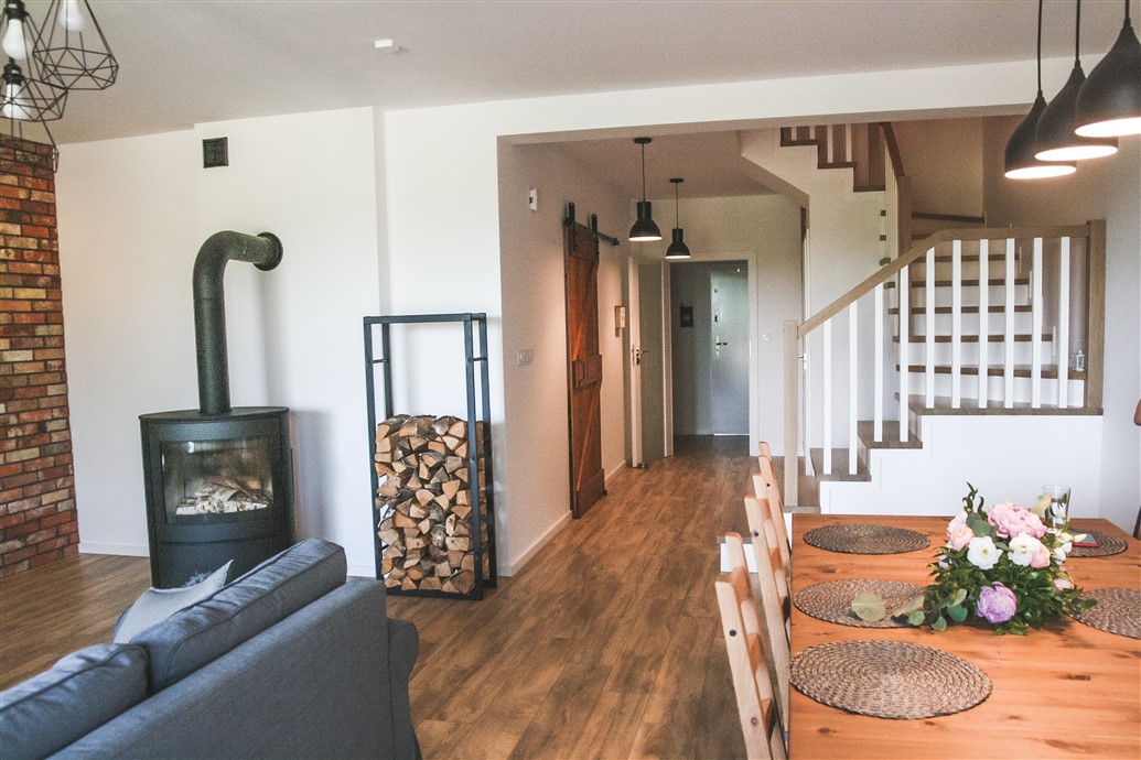 Schiebetür aus Massivholz, skandinavisches Interieur, Loft-Interieur, Küchentür, barn door, gebürstete Schiebetür, Küchenschiebetür, Backsteinmauer im Wohnzimmer, Kamin im Wohnzimmer, skandinavischer Stil in Wohnzimmer, offener Raum, Essecke im Wohnzimmer