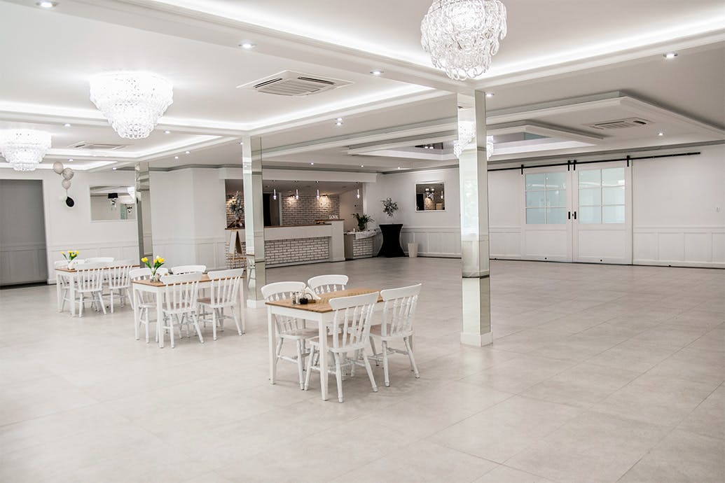 weiße Schiebetüren, ein großer Kristall-Kronleuchter, Große Schiebetüren, Doppelschiebetür, Schiebetüren mit Glas, weiße Holztüren mit Glas, Spiegel im Innenraum, Ballsaal