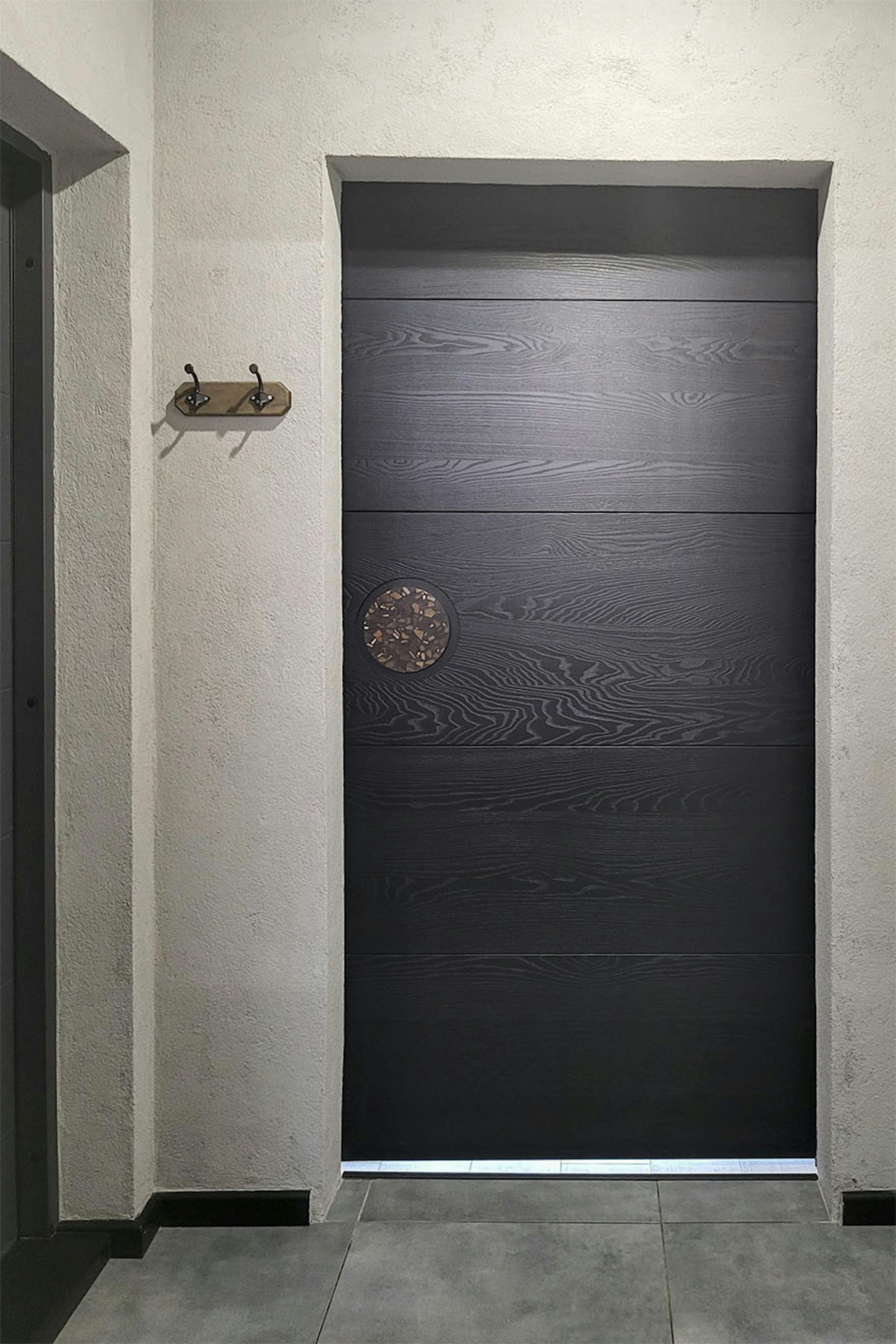 minimalistyczne czarne drzwi przesuwne w przedsionku