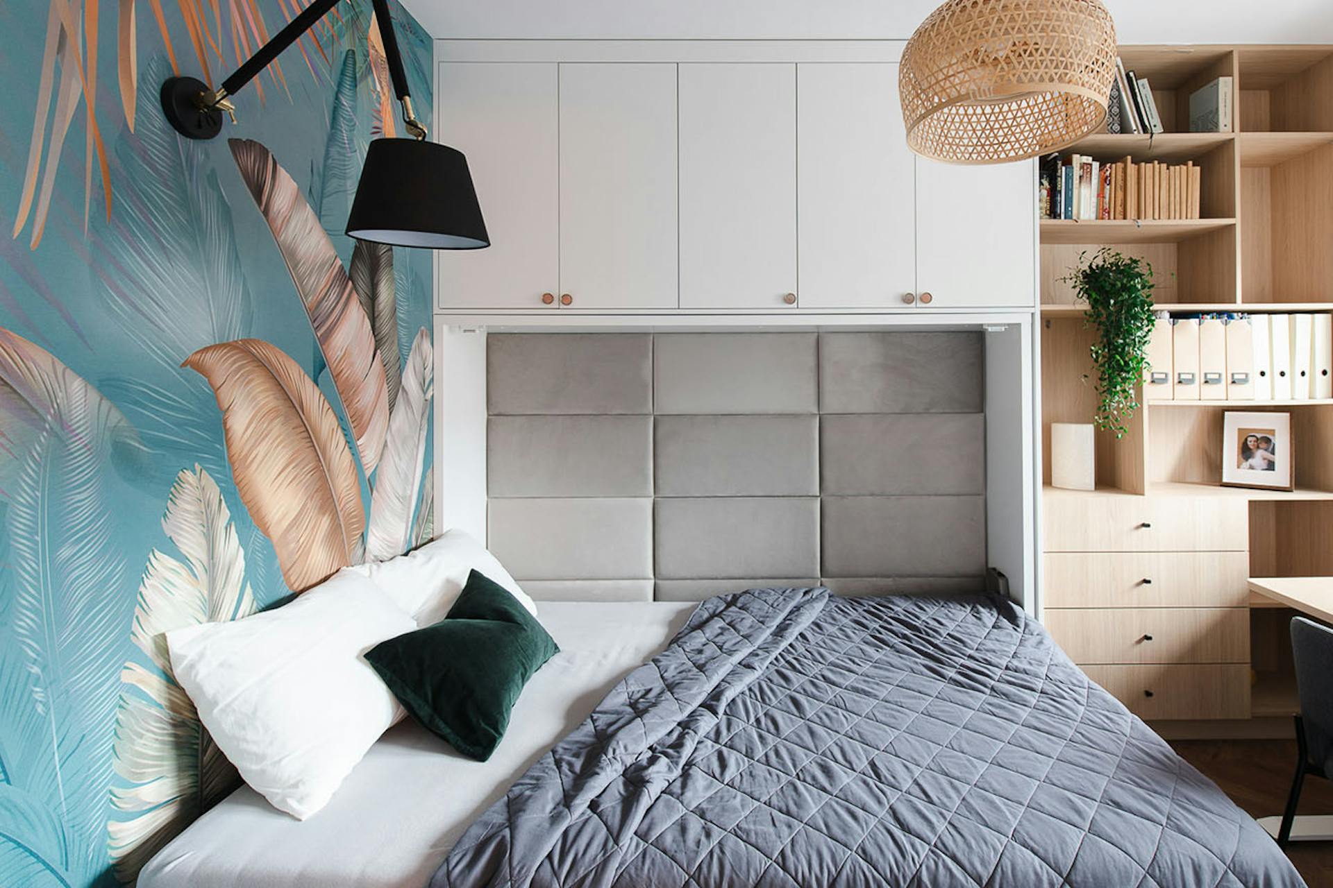 łóżko chowane w szafie i kolorowa tapeta na ścianie w małej sypialni