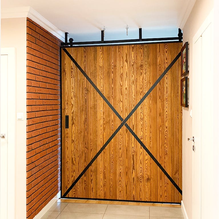 large sliding door, sliding wall, wooden sliding doors, sliding doors in a metal frame, brick on the wall
