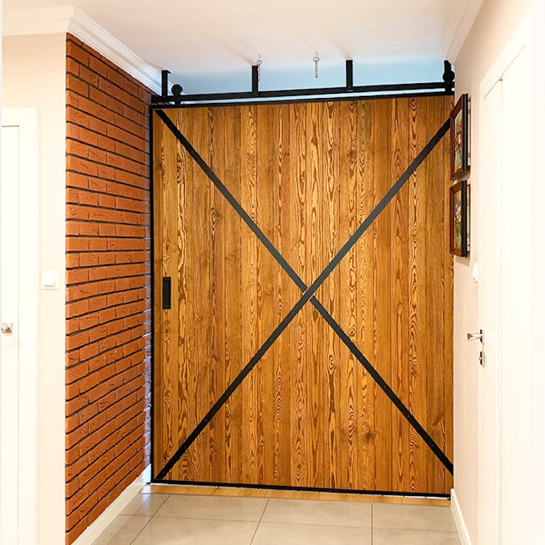large sliding door, sliding wall, wooden sliding doors, sliding doors in a metal frame, brick on the wall