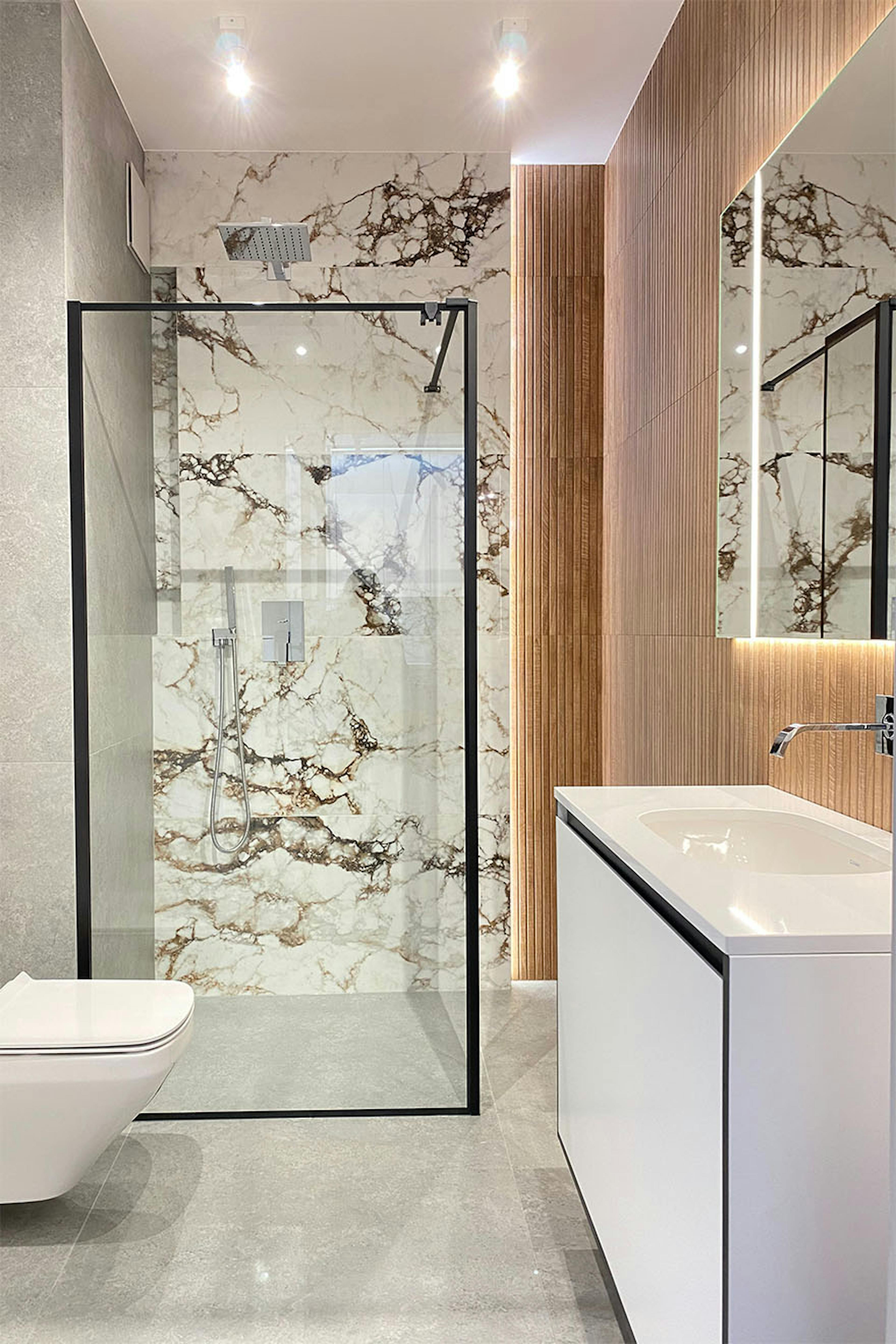 minimalistische duschkabinen in einem modernen badezimmer, fliesen mit steinmuster, weiße armaturen im badezimmer