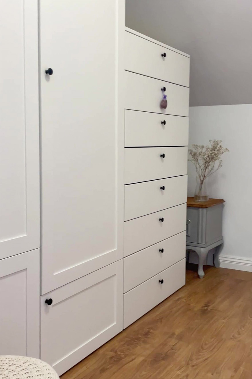 weiße Kleiderschränke und Kommoden unter Dachschräge im Ankleidezimmer