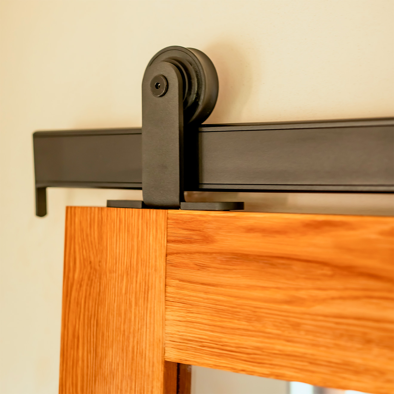 Robuste schwarze Beschläge im Loft-Stil und obere Führungsschiene für Holzschiebetüren – Details.